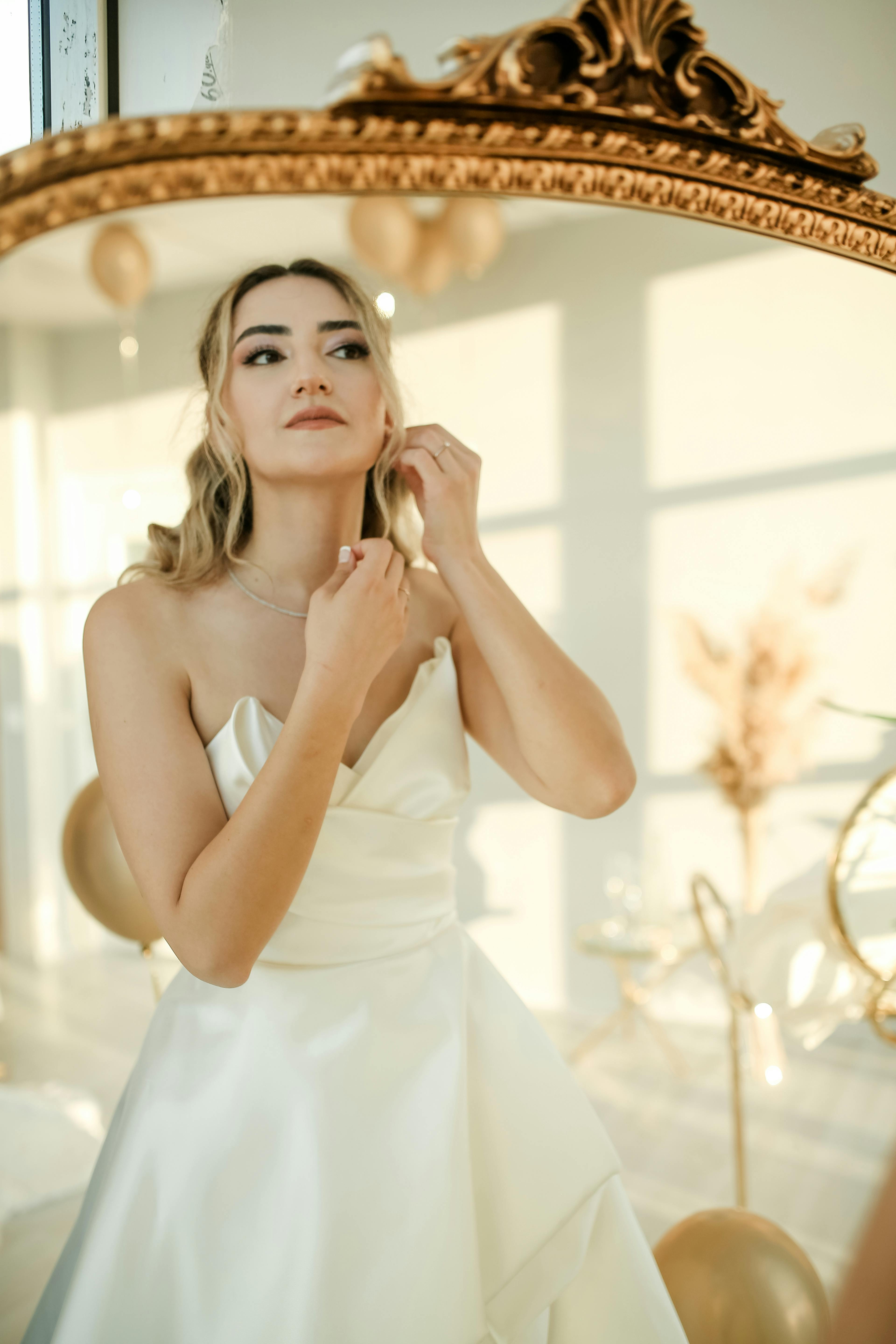 A bride preparing in front of a mirror | Source: Pexels
