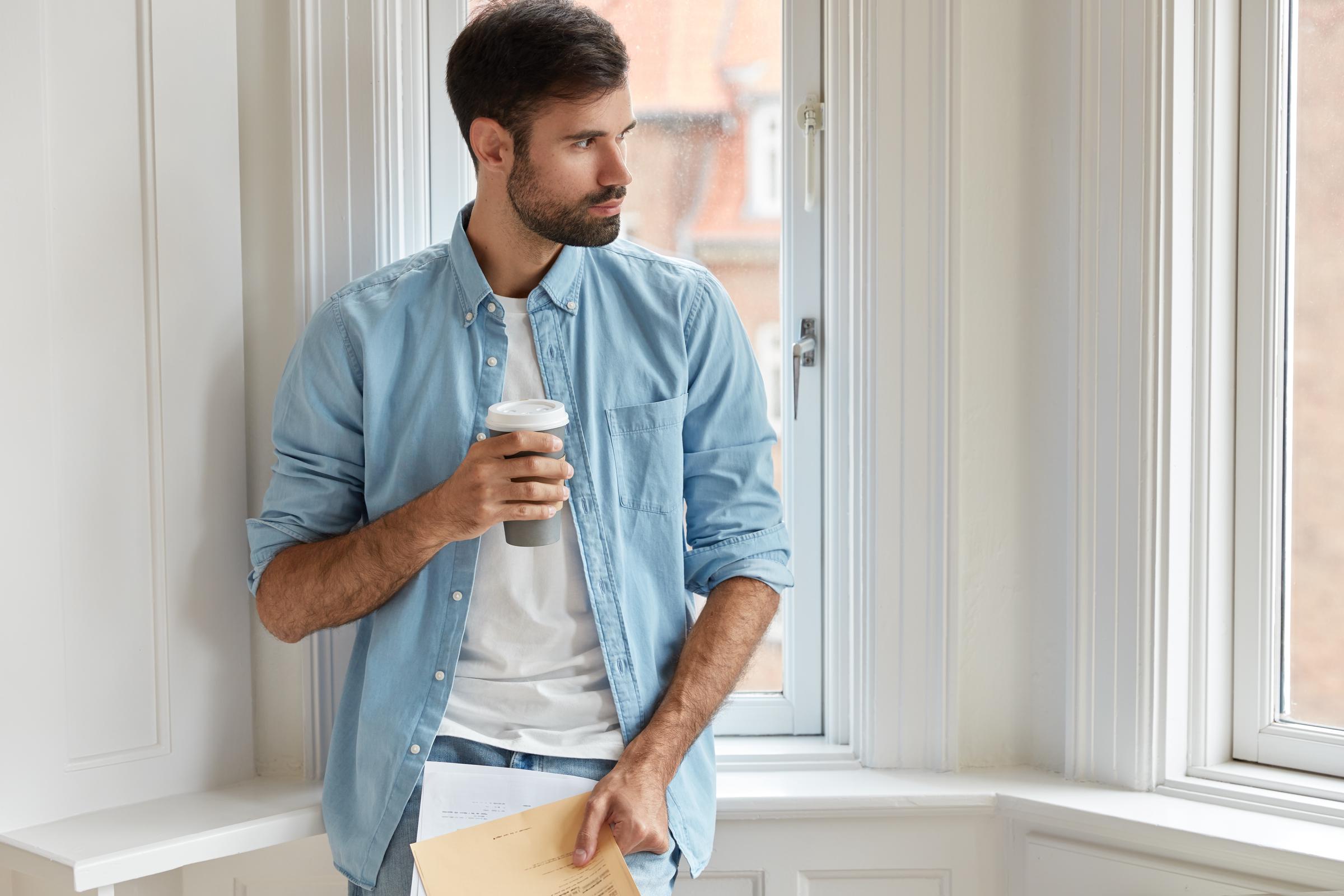 A man drinking coffee | Source: Freepik