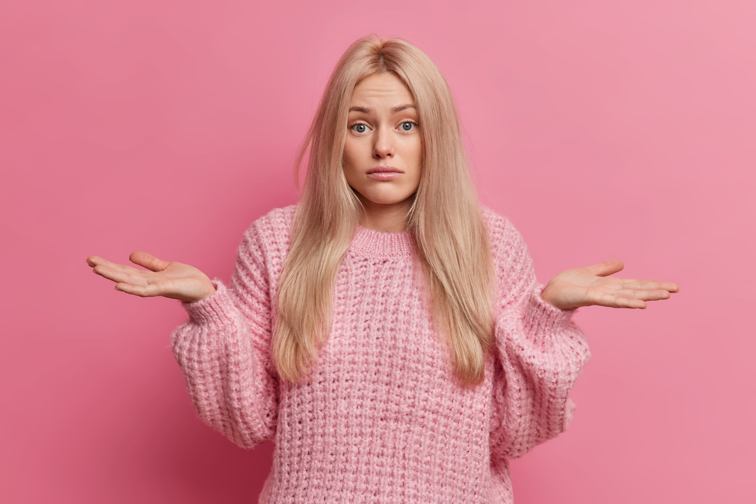 A frustrated woman shrugging | Source: Freepik