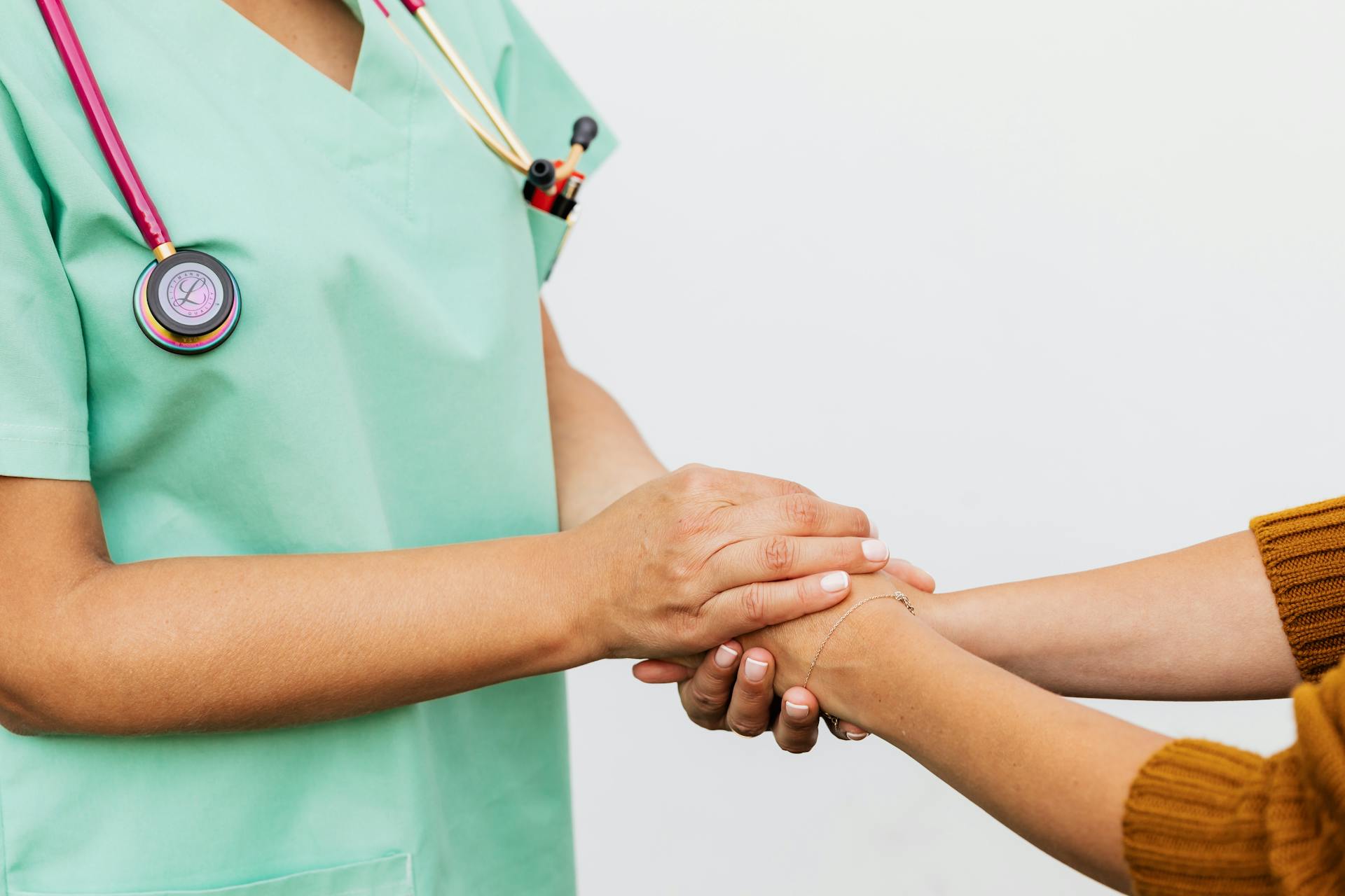 A nurse holding a patient's hands | Source: Pexels