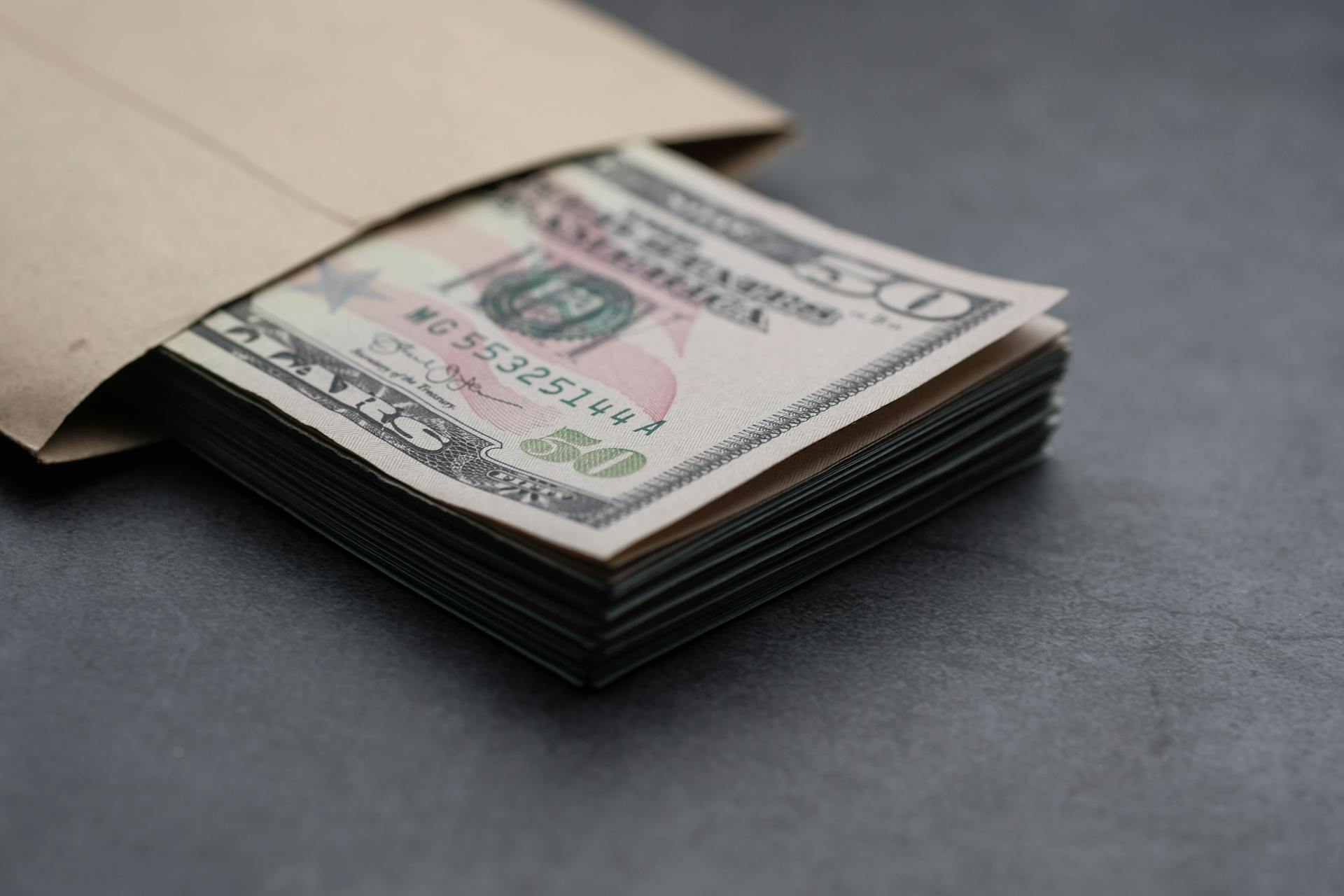 A stack of dollar bills in an envelope | Source: Pexels