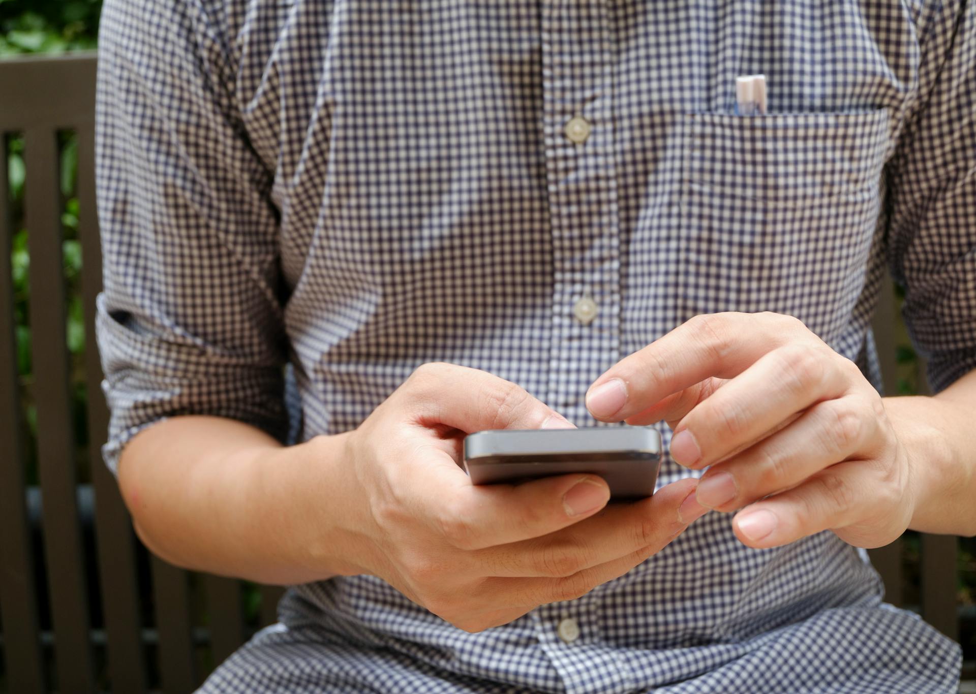 Close-up of a man using a smartphone | Source: Pexels