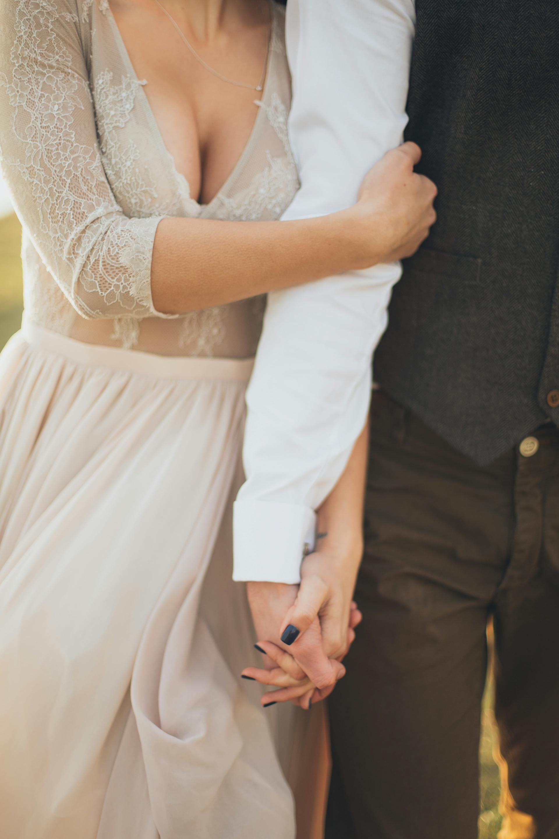 A closeup shot of a man and woman holding hands | Source: Pexels