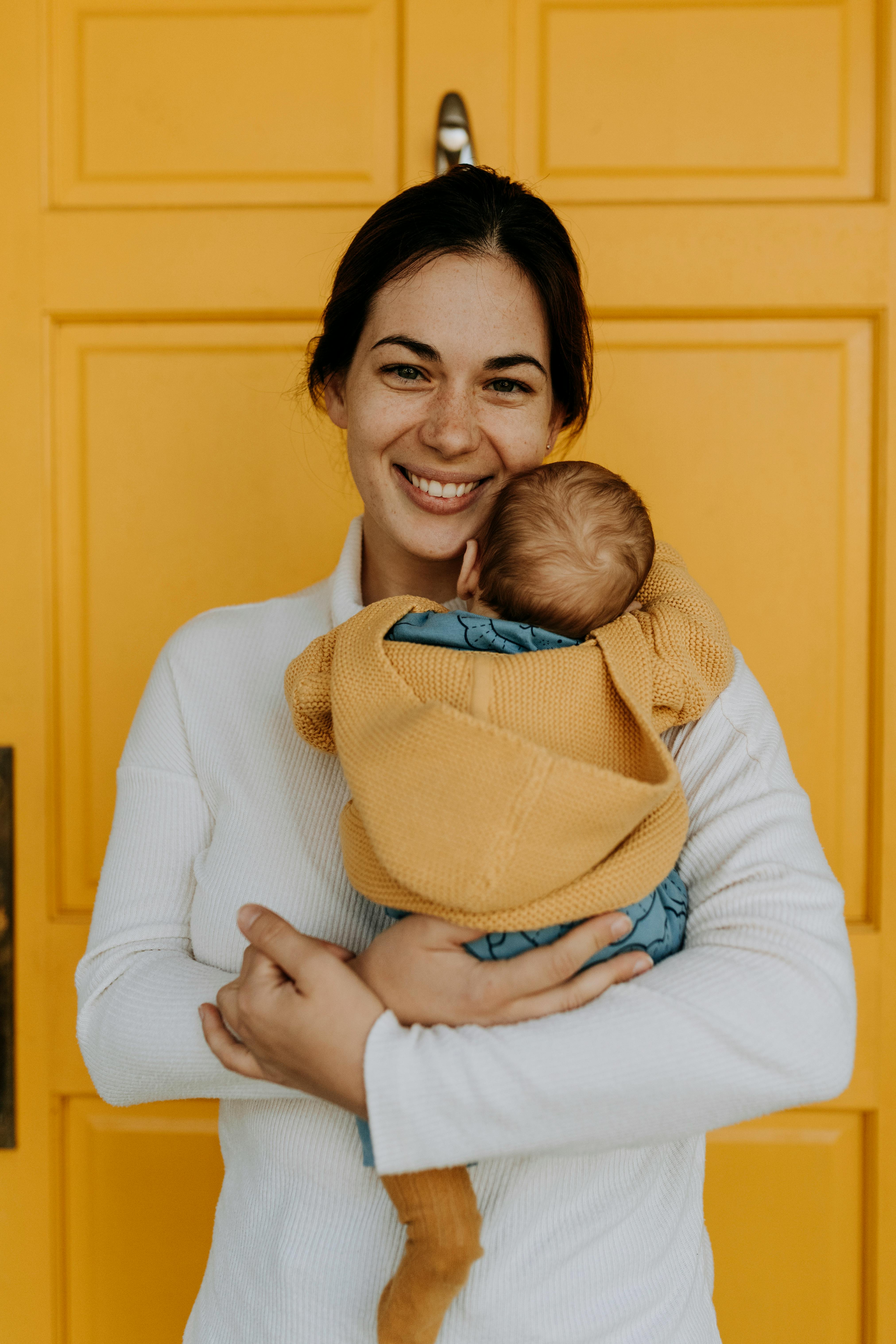 A mother holding her child | Source: Pexels