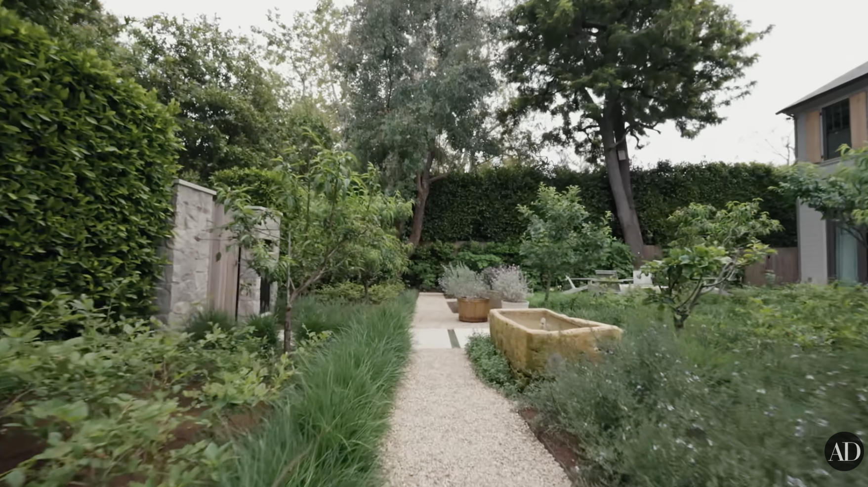 Jennifer Garner's outdoor garden lined with fruit trees and bushes as seen on Architectural Digest's YouTube video posted on September 4, 2024. | Source: YouTube/Architectural Digest