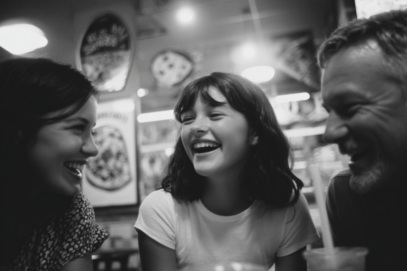A teen girl and her parents laughing in a pizza parlor | Source: Midjourney
