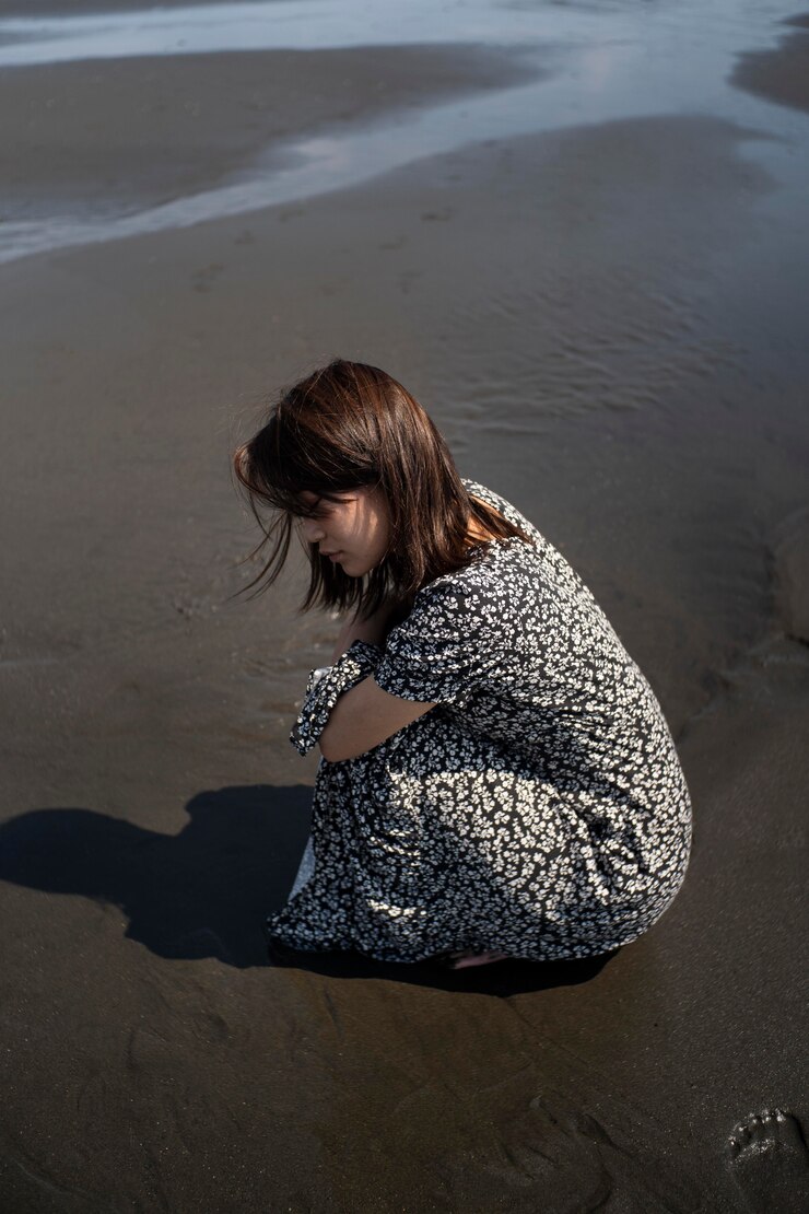 A sad woman on a beach | Source: Freepik