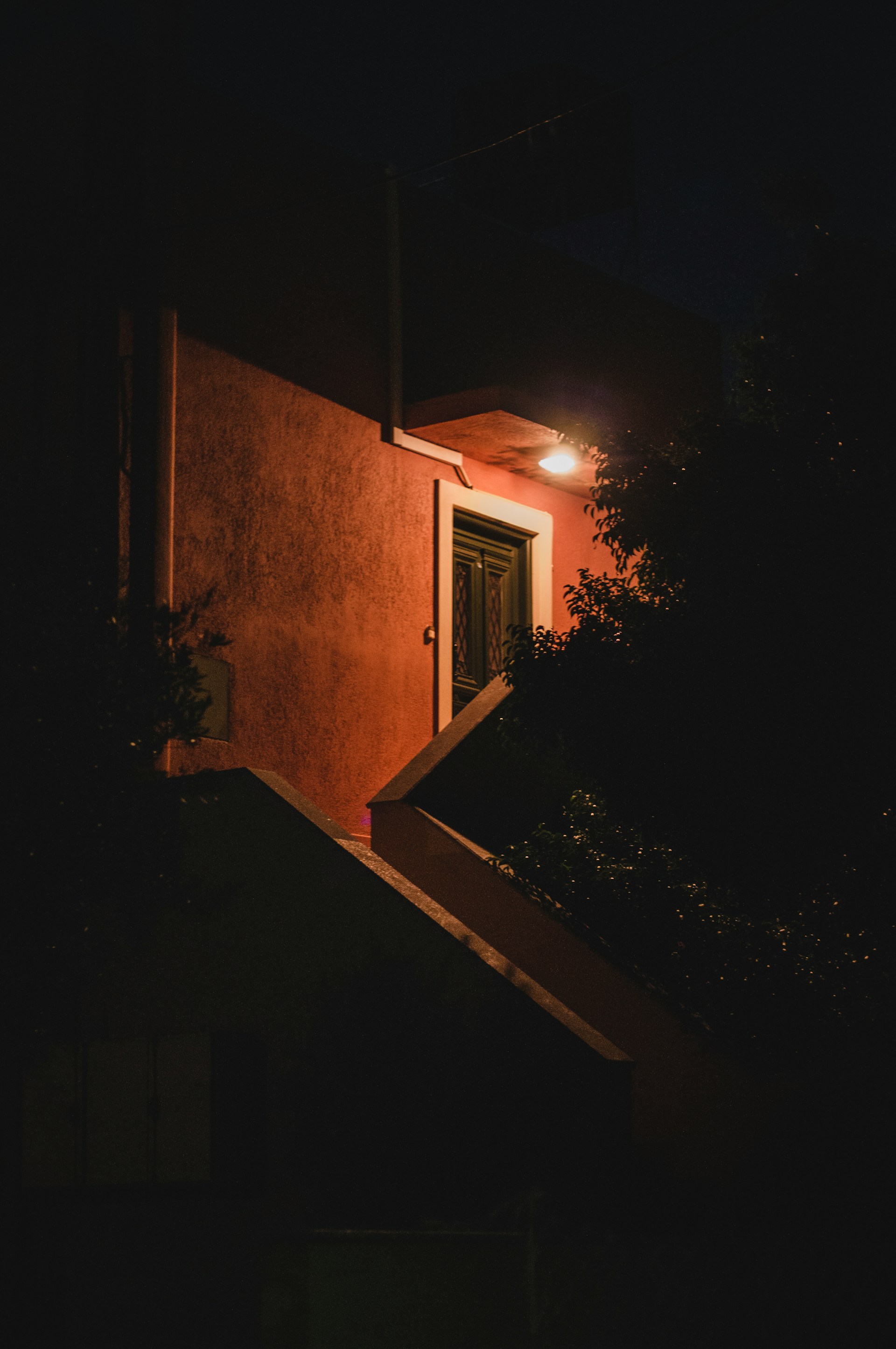 Night shot of a building with a window | Source: Unsplash