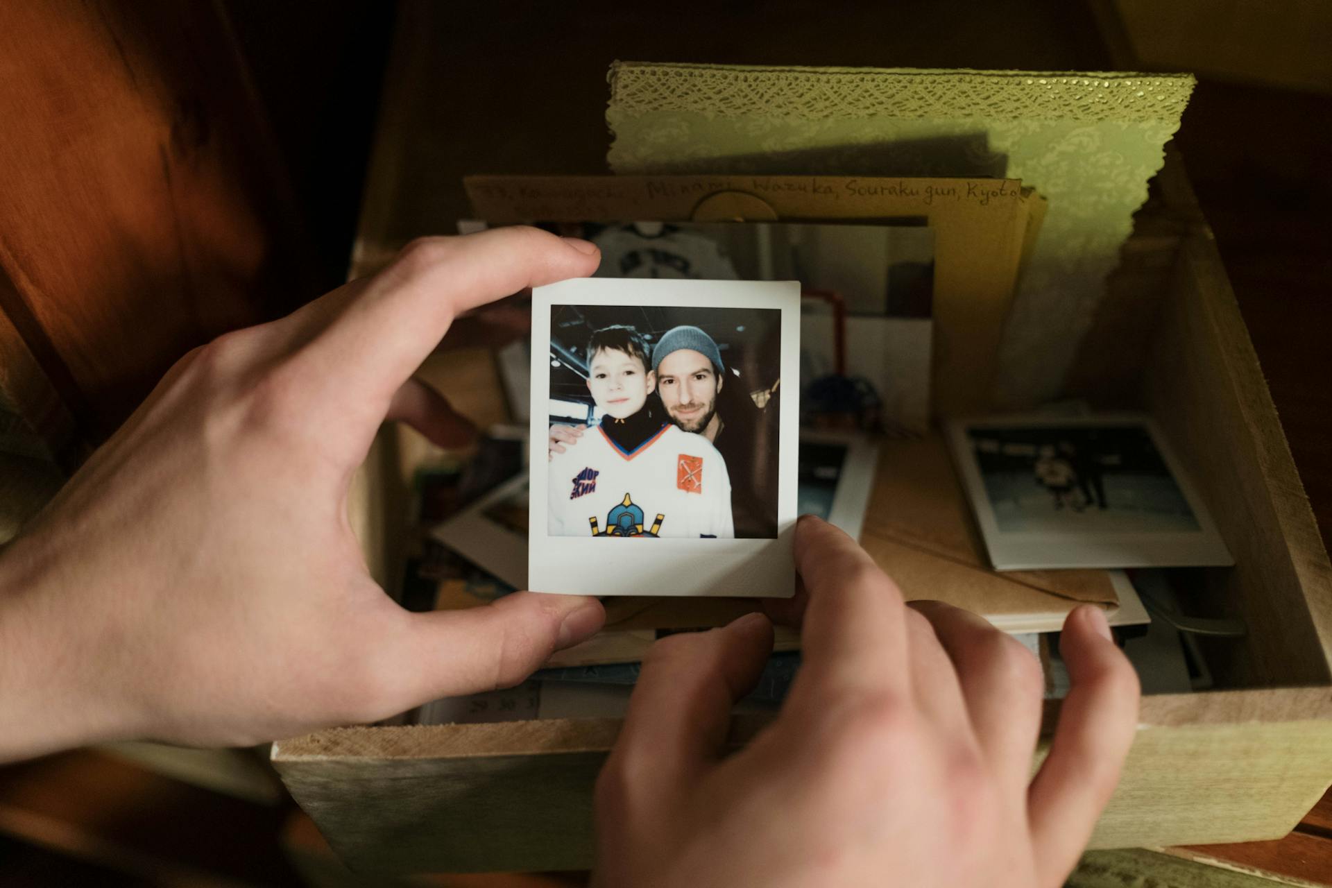 A close-up of a person holding a Polaroid picture | Source: Pexels