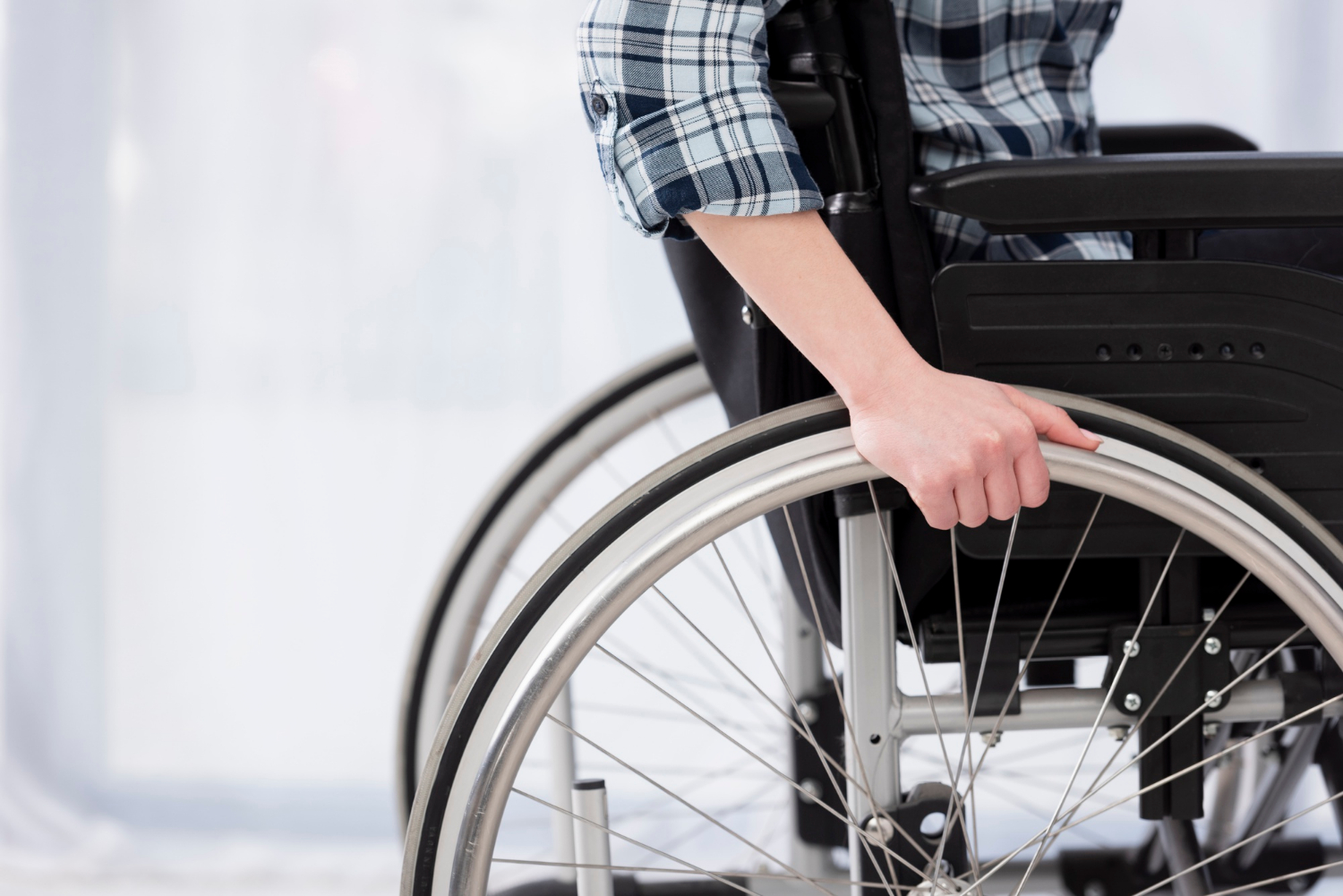 Close-up shot of a person sitting on their wheelchair | Source: Freepik