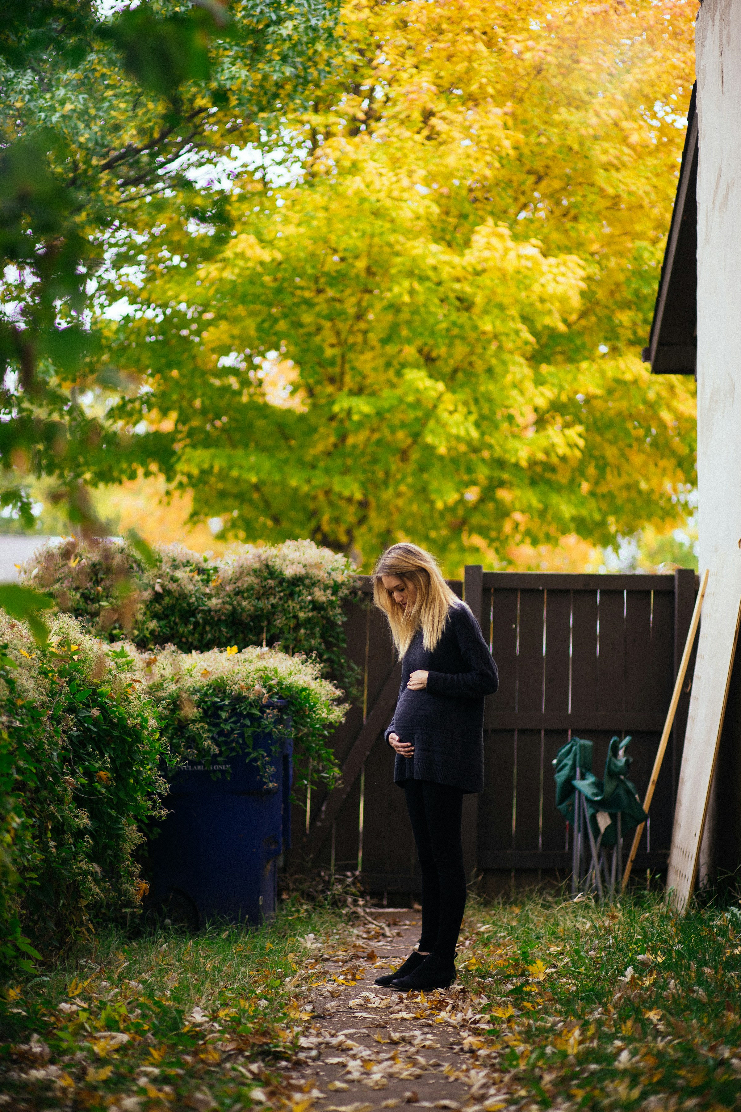 A pregnant woman standing outside her house | Source: Unsplash