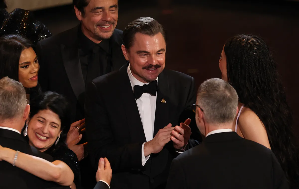 Paul Thomas Anderson celebrates with US actress Chase Infiniti, US actor Leonardo DiCaprio and Puerto Rican actor Benicio Del Toro as they accept the award for Best Picture for "One Battle After Another" onstage during the 98th Annual Academy Awards at the Dolby Theatre in Hollywood, California on March 15, 2026. | Source: Getty Images