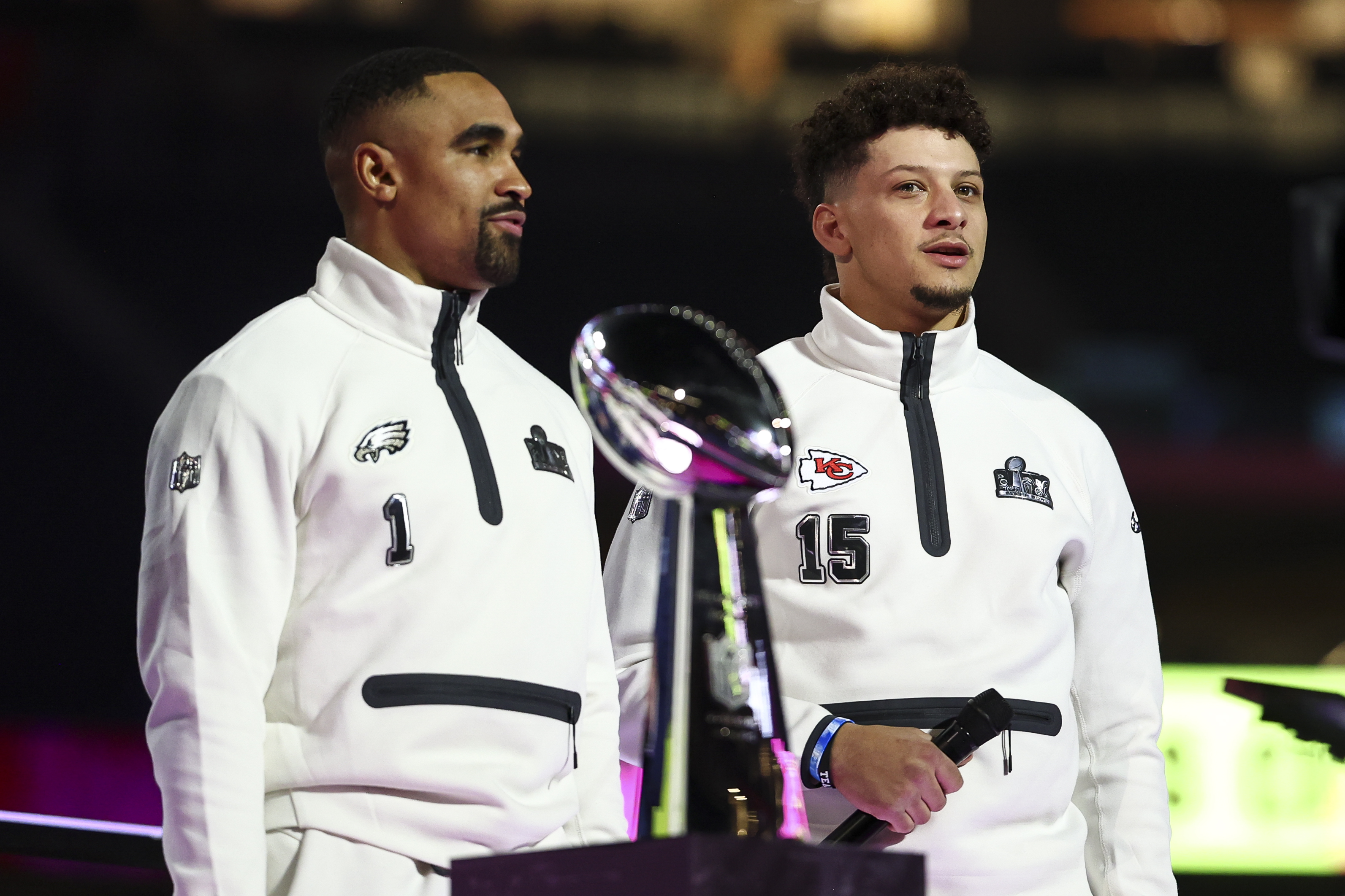 Jalen Hurts and Patrick Mahomes standing behind the Vince Lombardi Trophy during Super Bowl LIX Opening Night in New Orleans, Louisiana on February 3, 2025. | Source: Getty Images