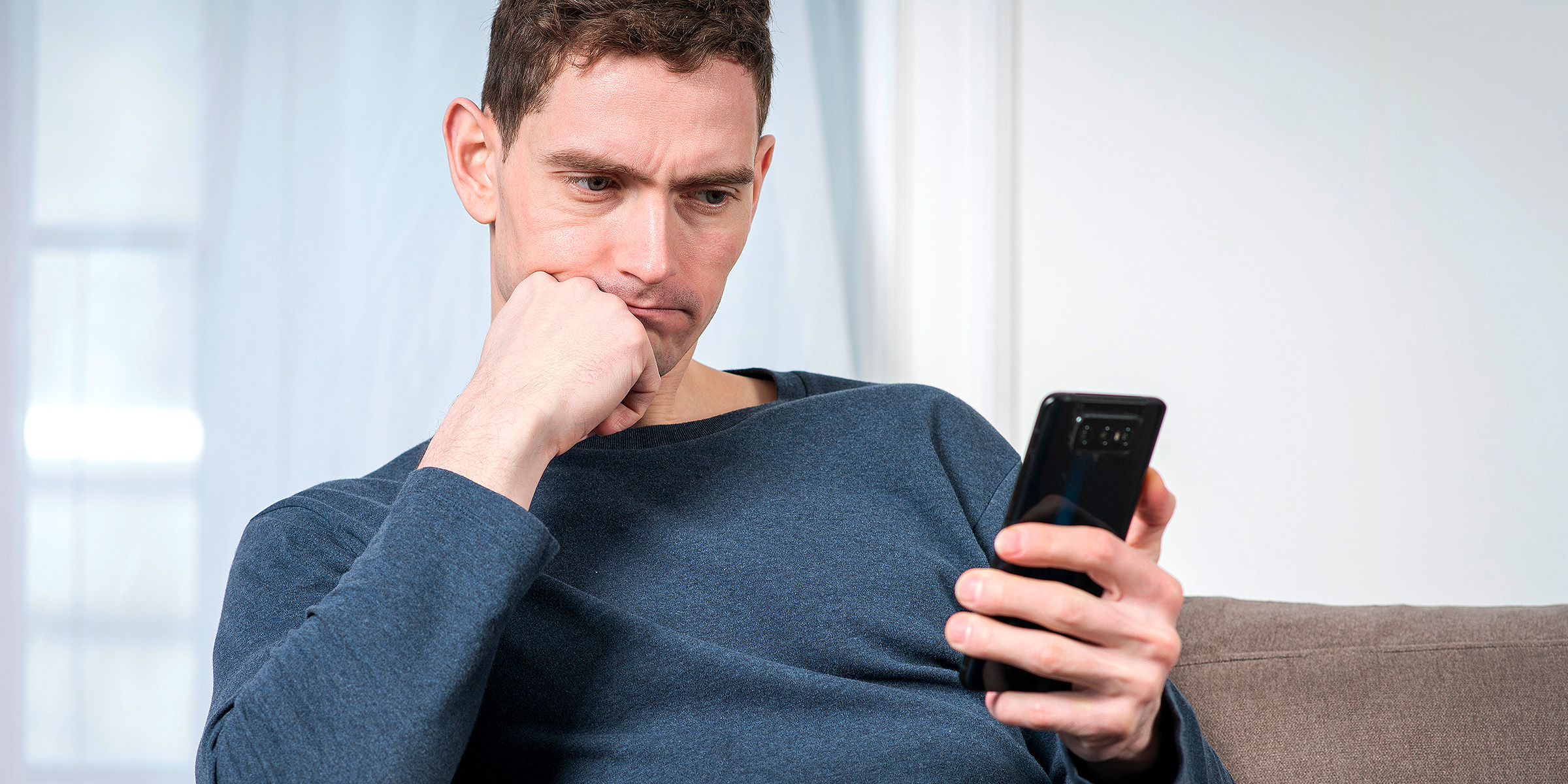 A man holding a phone | Source: Shutterstock