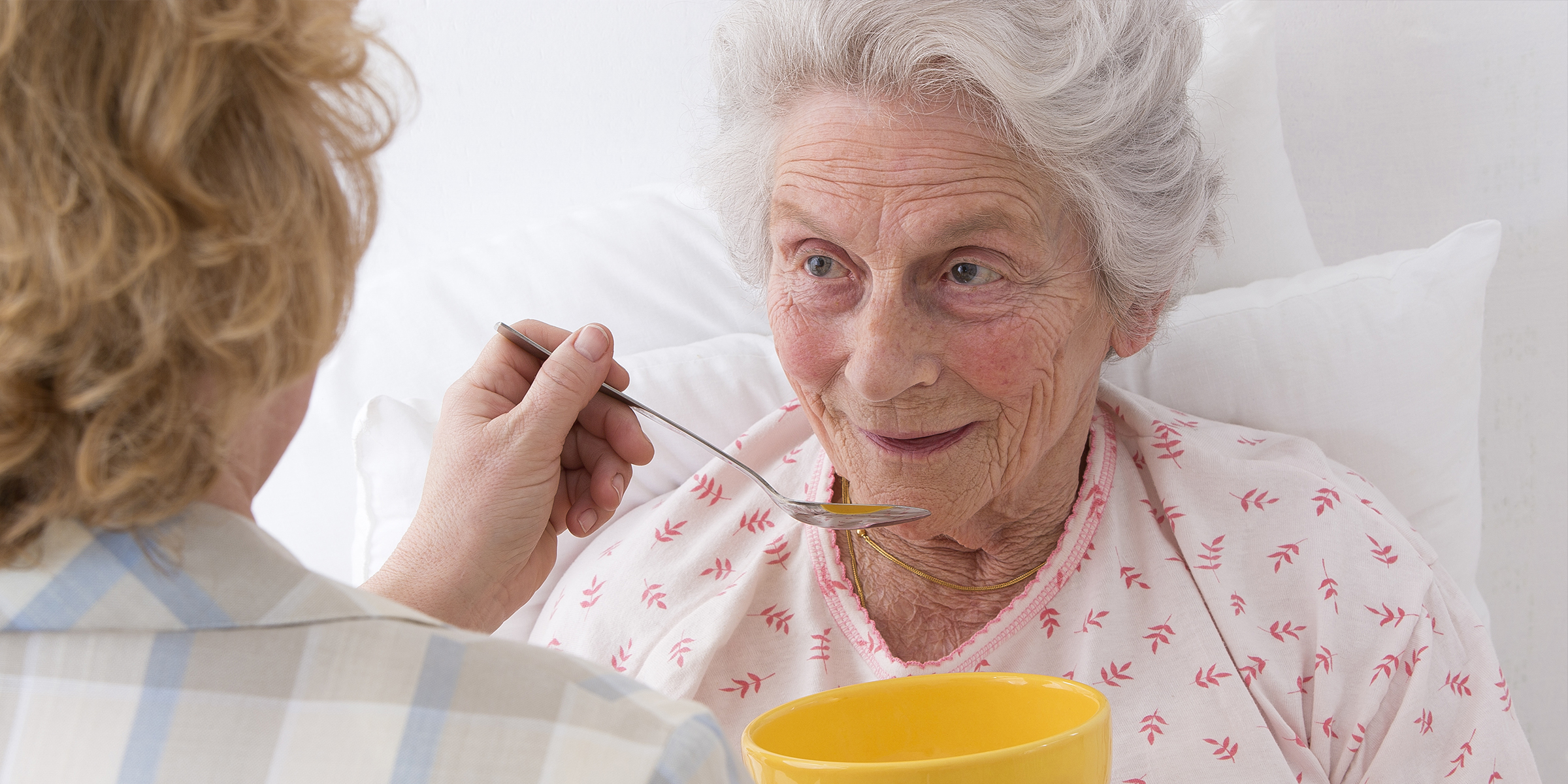 A woman looking after an elderly person | Source: Shutterstock