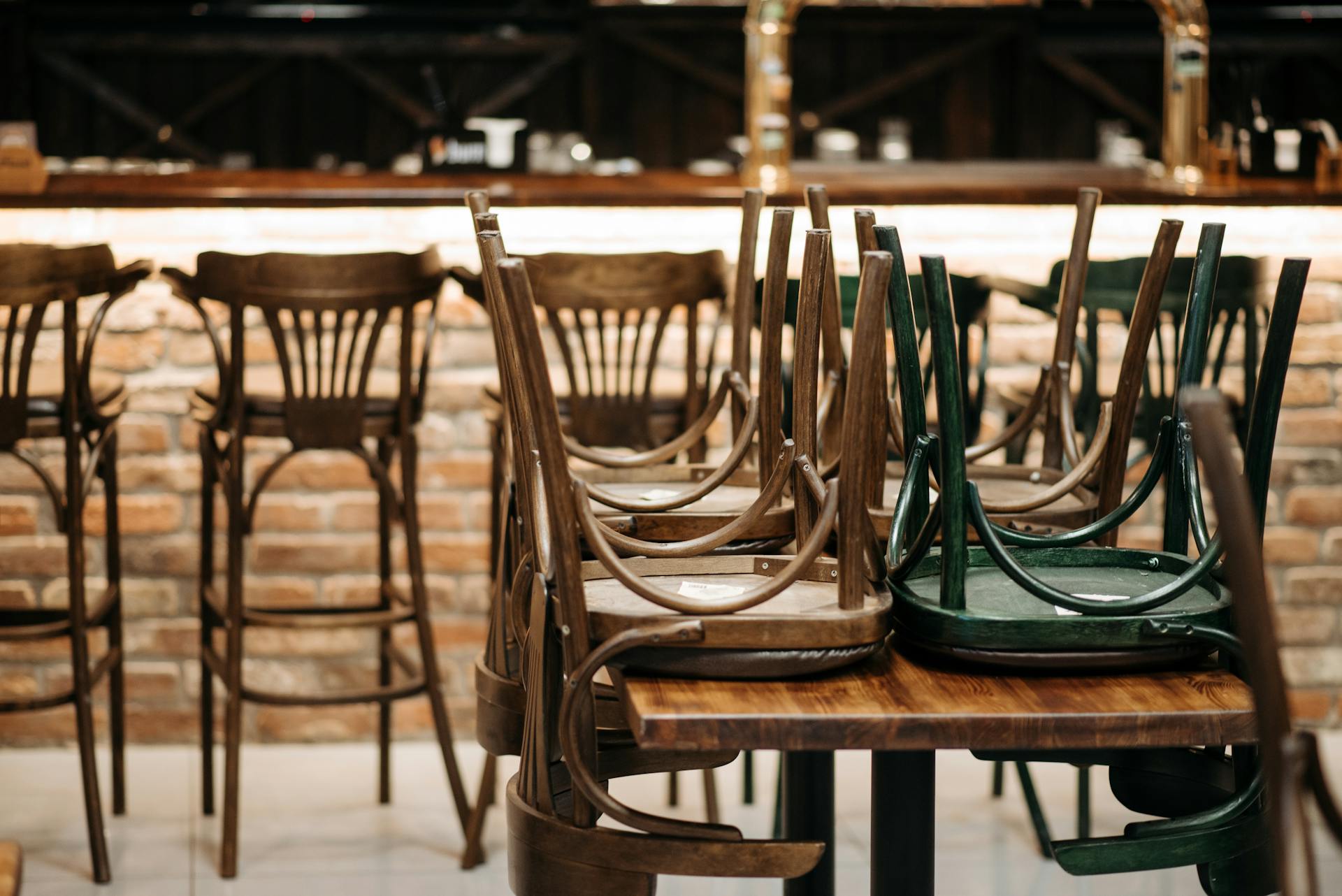 Wooden chairs stacked on a table | Source: Pexels