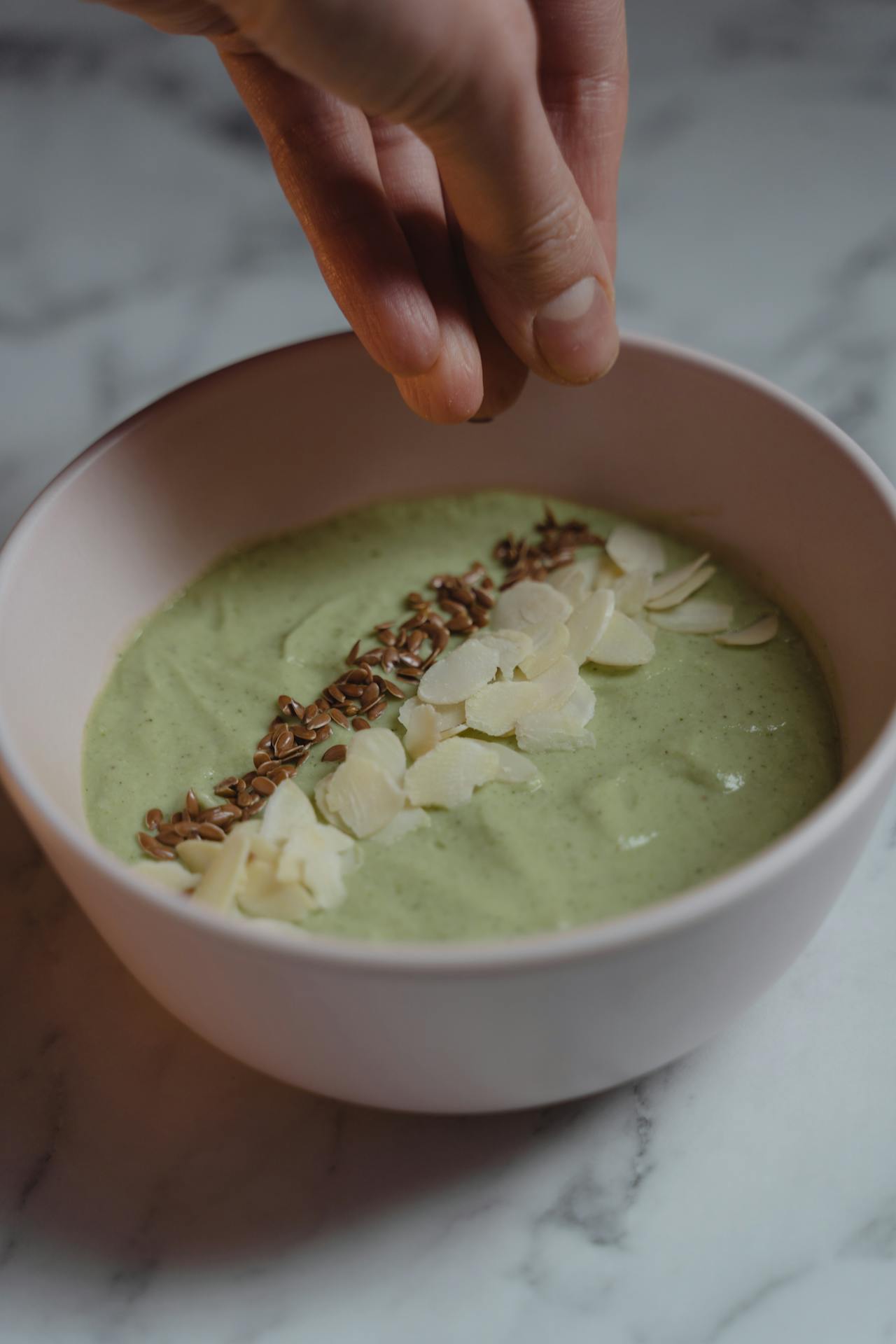 A woman garnishing a dish | Source: Pexels