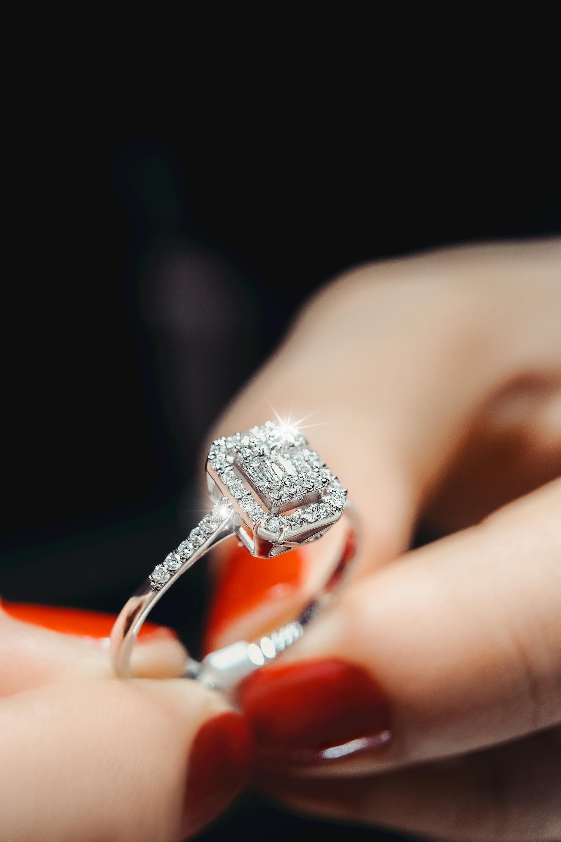 A close-up shot of a woman holding a diamond ring | Source: Pexels