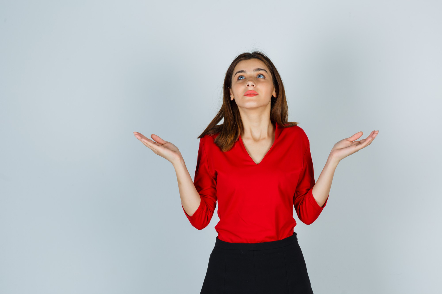 A woman shrugging indifferently | Source: Freepik