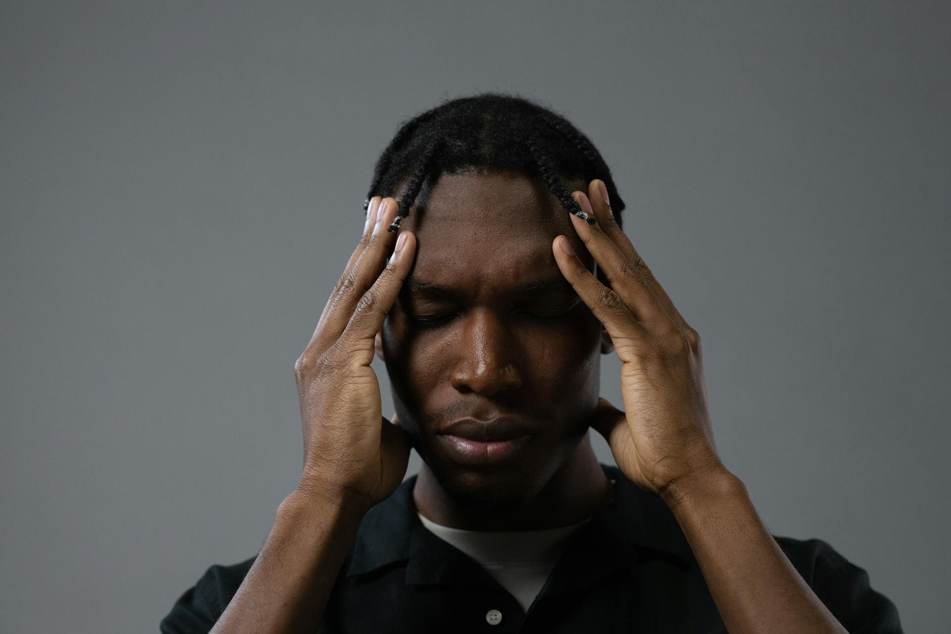 A tense man rubbing his temples | Source: Pexels