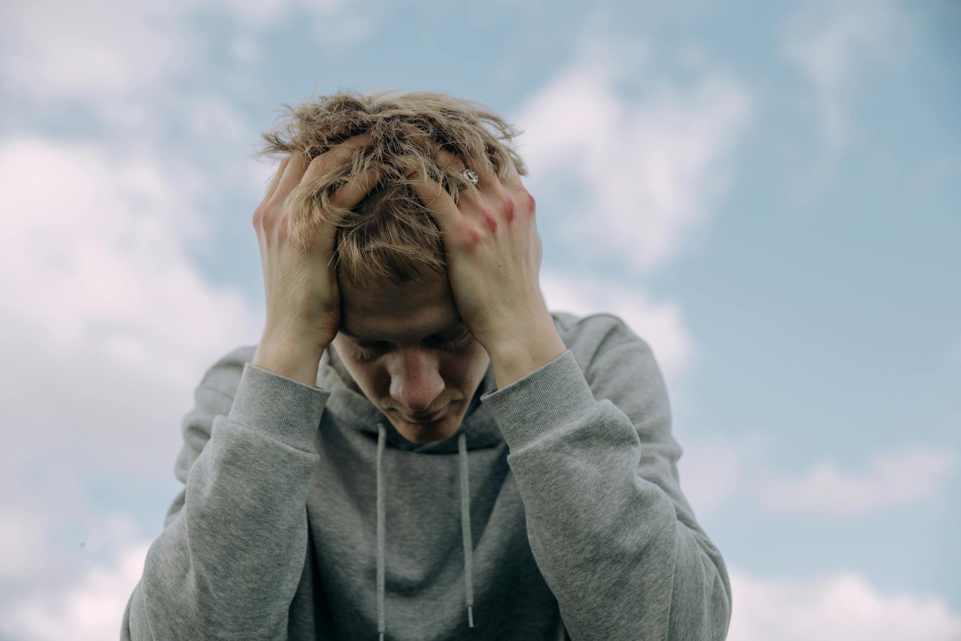 A man sitting with his head in his hands | Source: Pexels