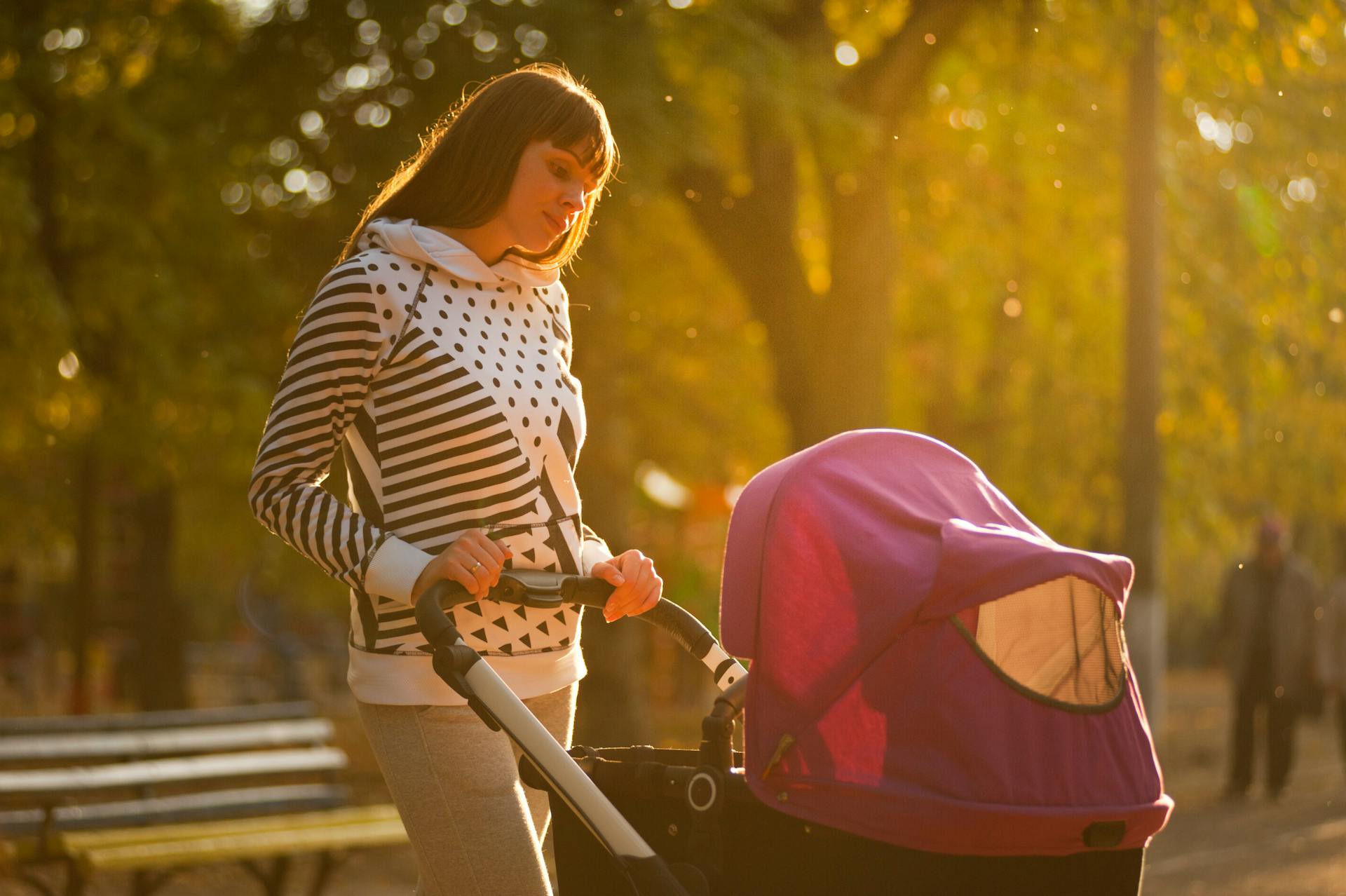 A woman holding a baby stroller | Source: Pexels