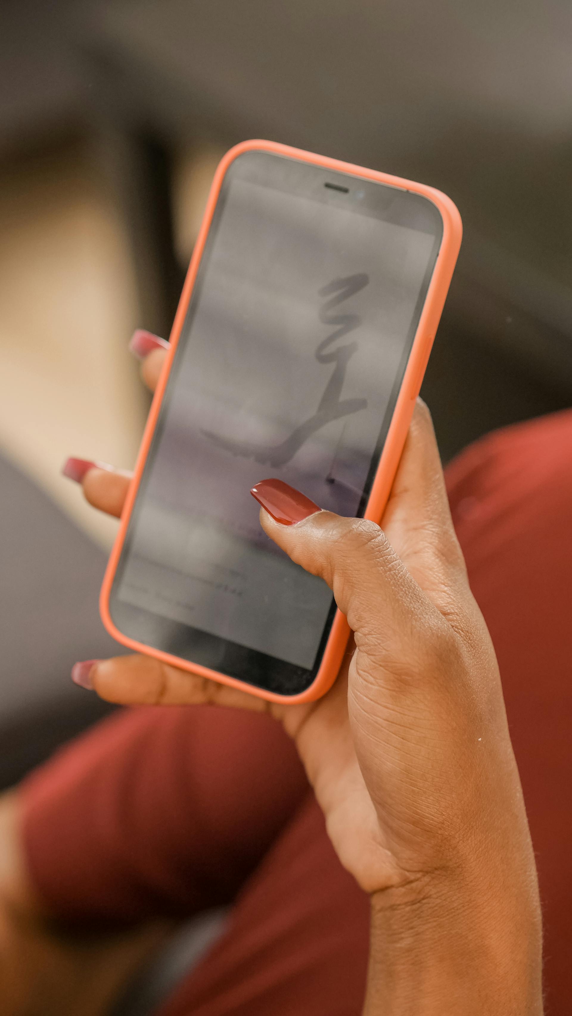 A woman scrolling on her cell phone | Source: Pexels