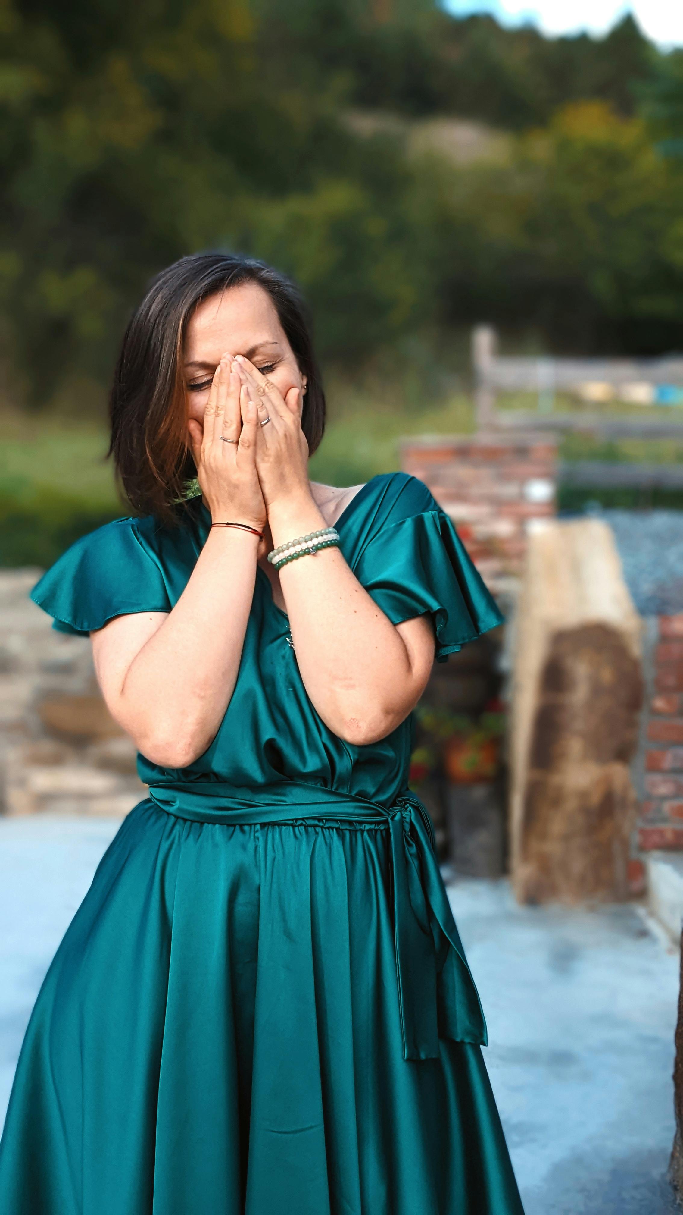 An emotional woman with her hands over her face | Source: Pexels