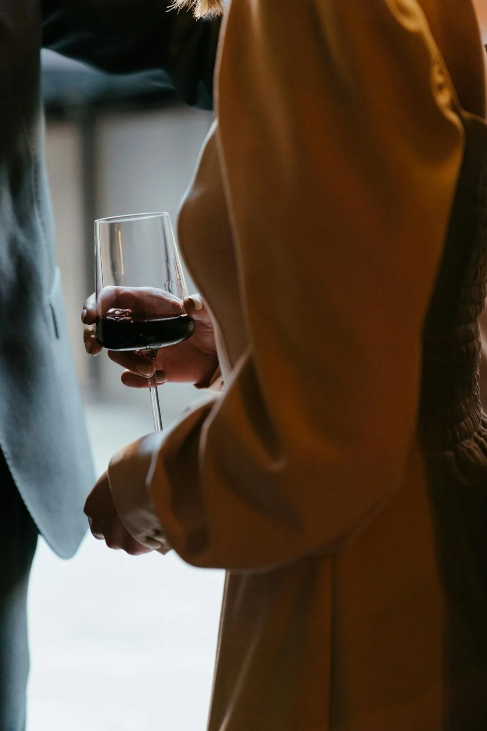 A woman holding a glass of red wine | Source: Pexels