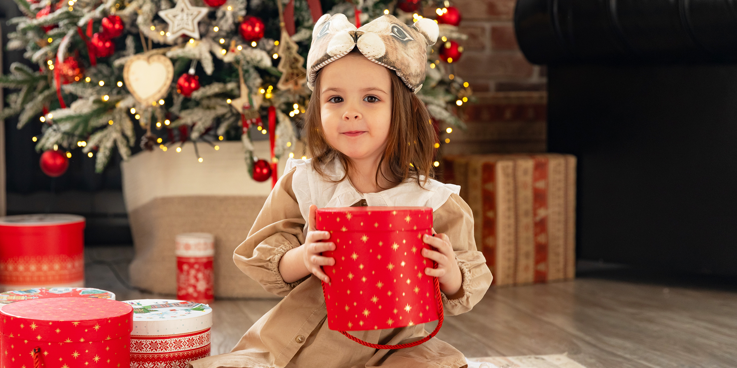 A girl holding her Christmas gifts | Source: Shutterstock