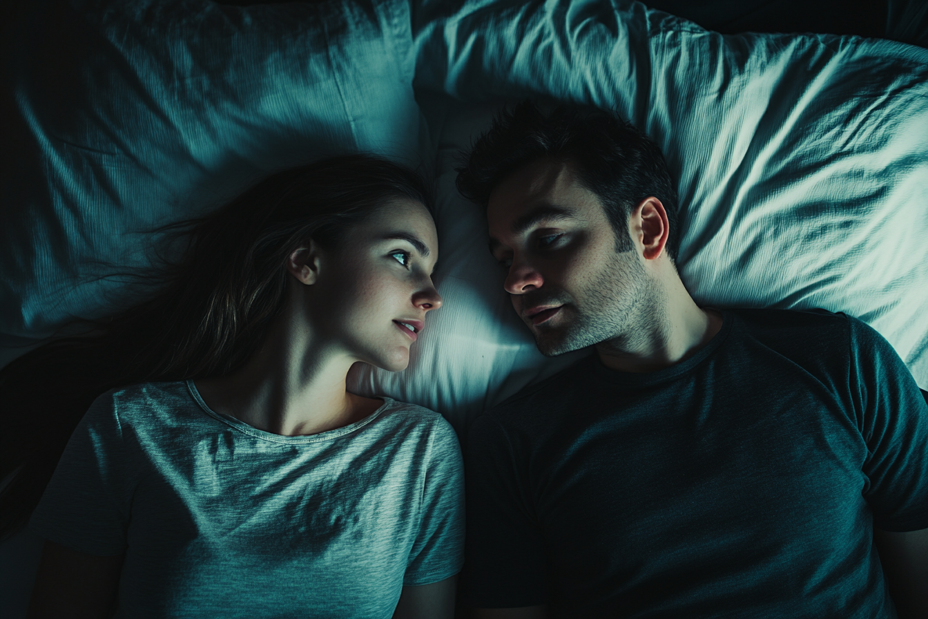 A couple having a conversation in bed | Source: Midjourney