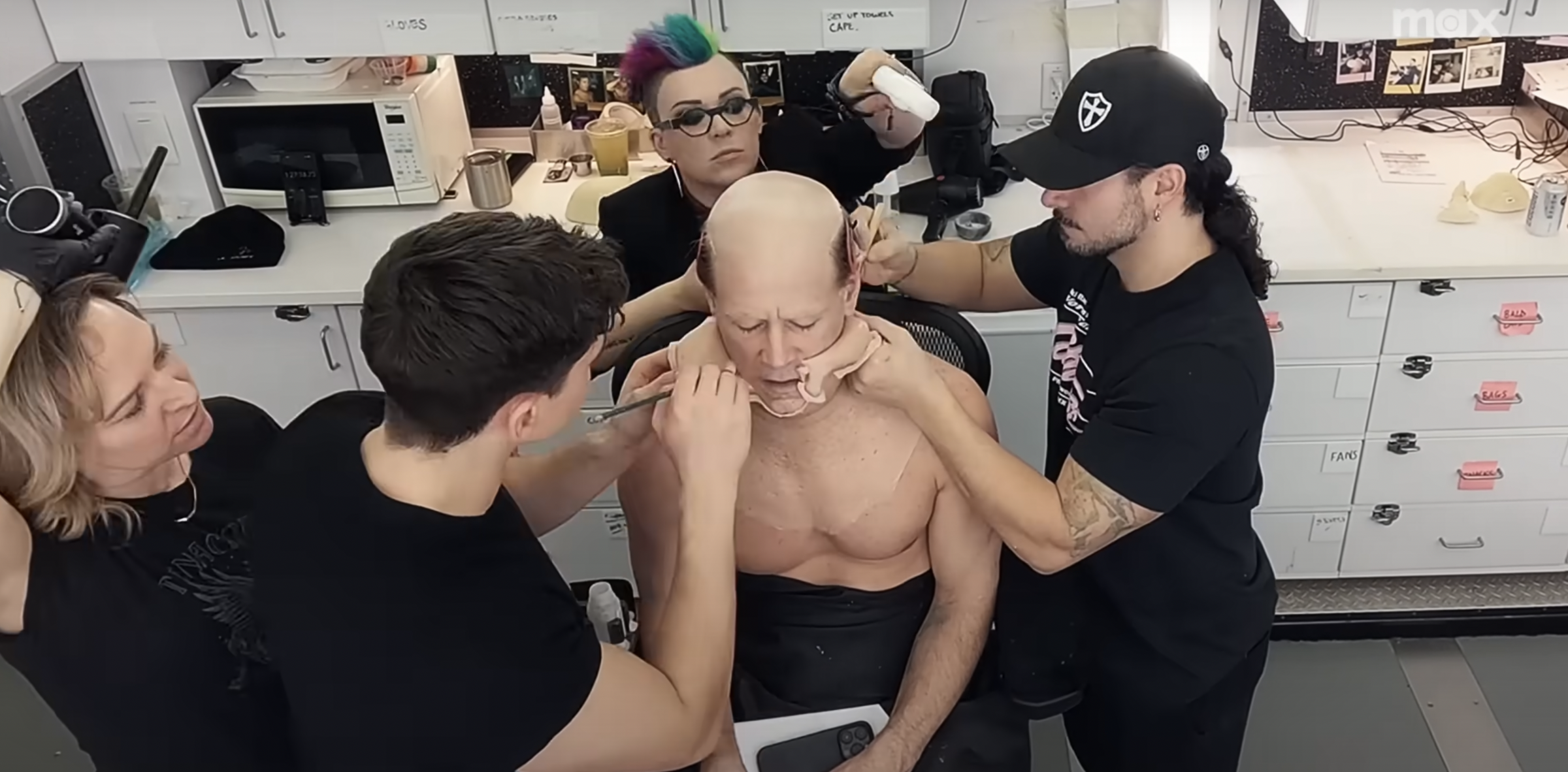 Colin Farrell and his makeup team | Source: YouTube/Max