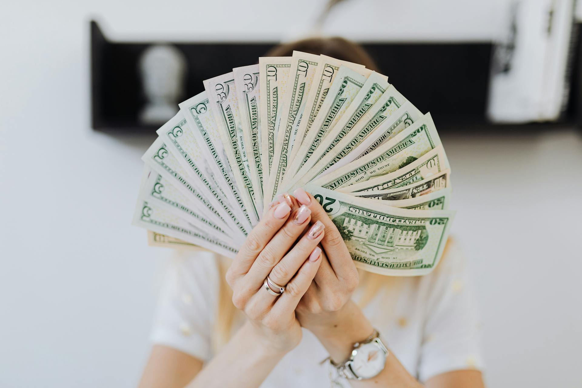 A woman holding money | Source: Pexels
