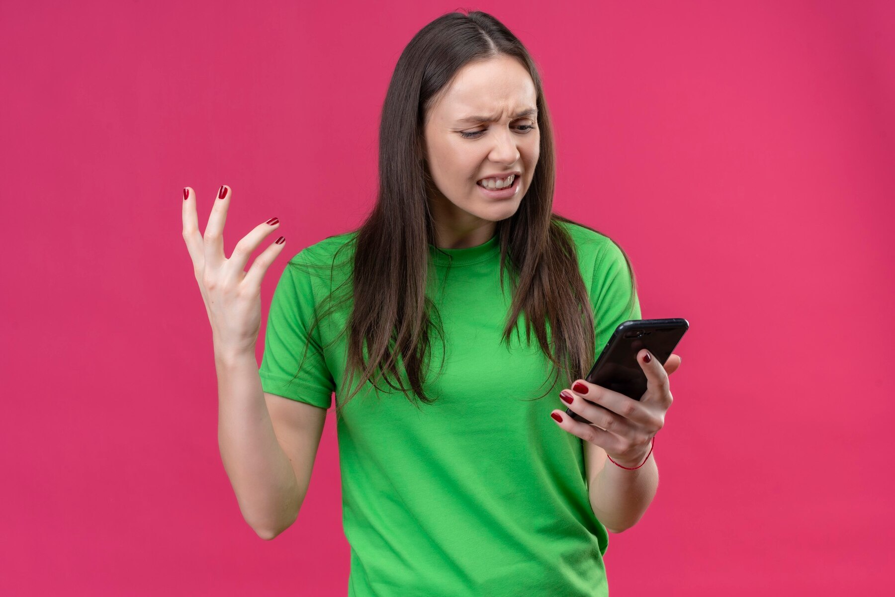 Una mujer enojada mirando su teléfono | Fuente: Freepik