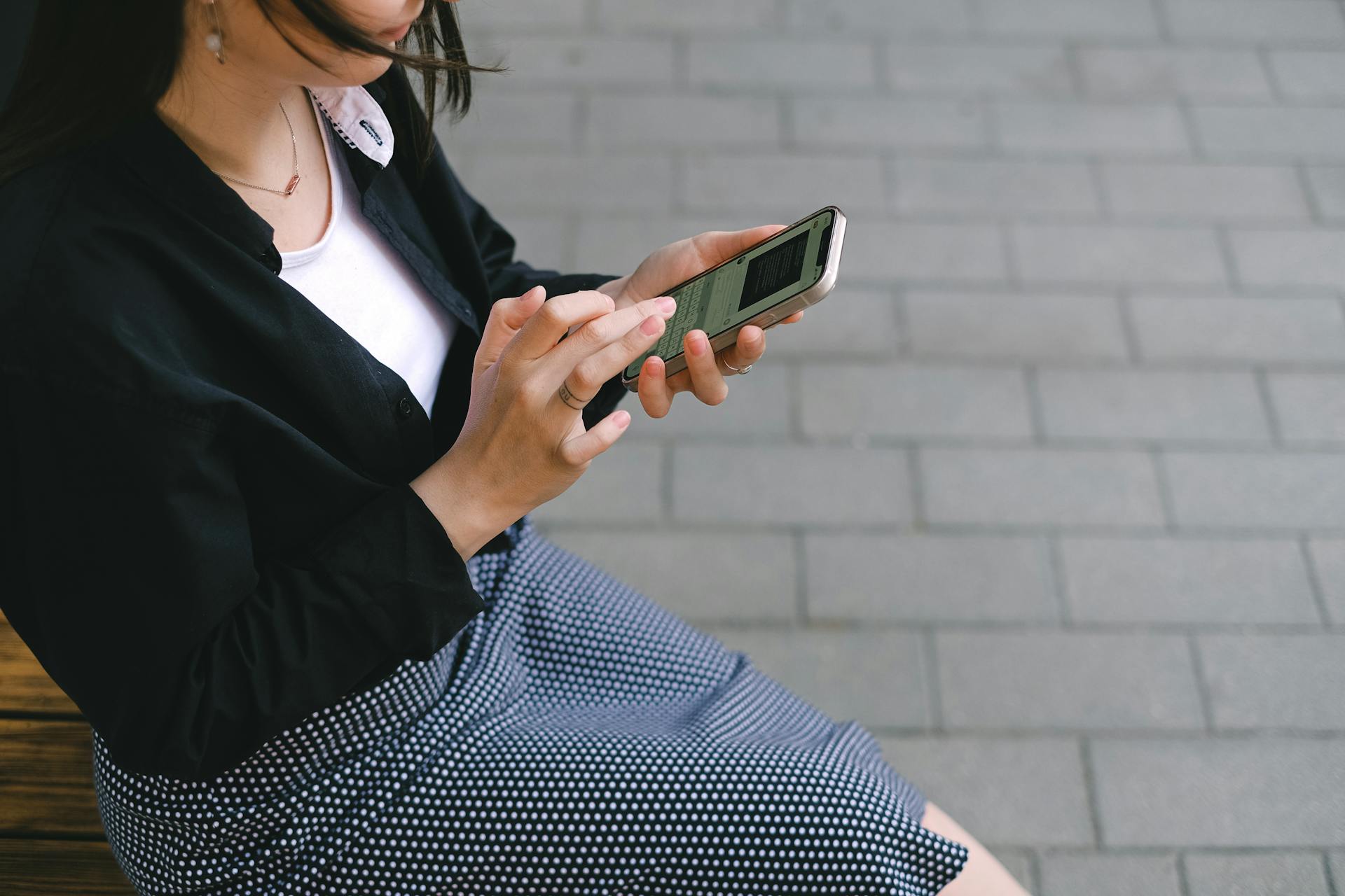A woman checking messages on her phone | Source: Pexels
