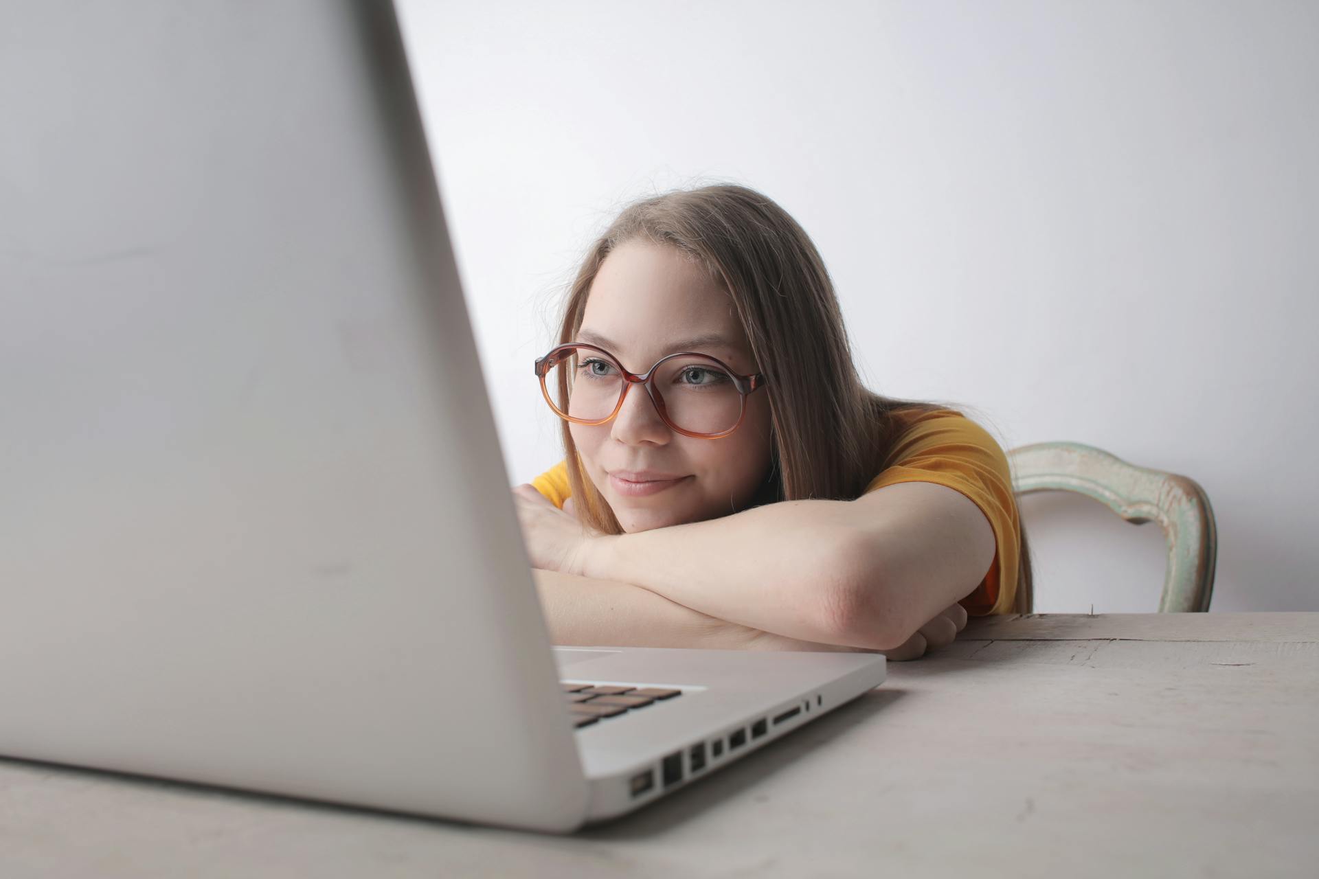 A woman smiling at her laptop | Source: Pexels