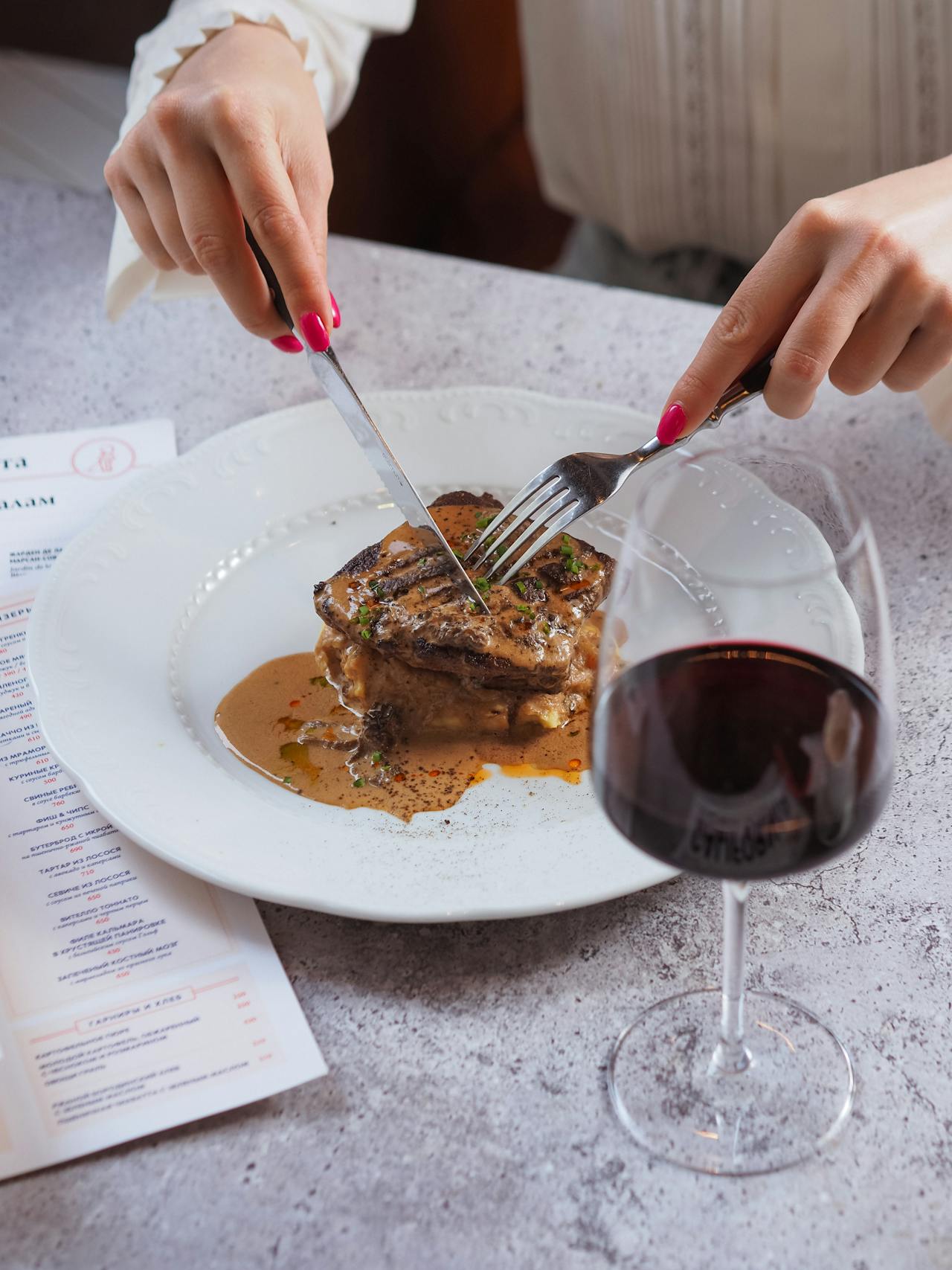 A woman eating steak | Source: Pexels
