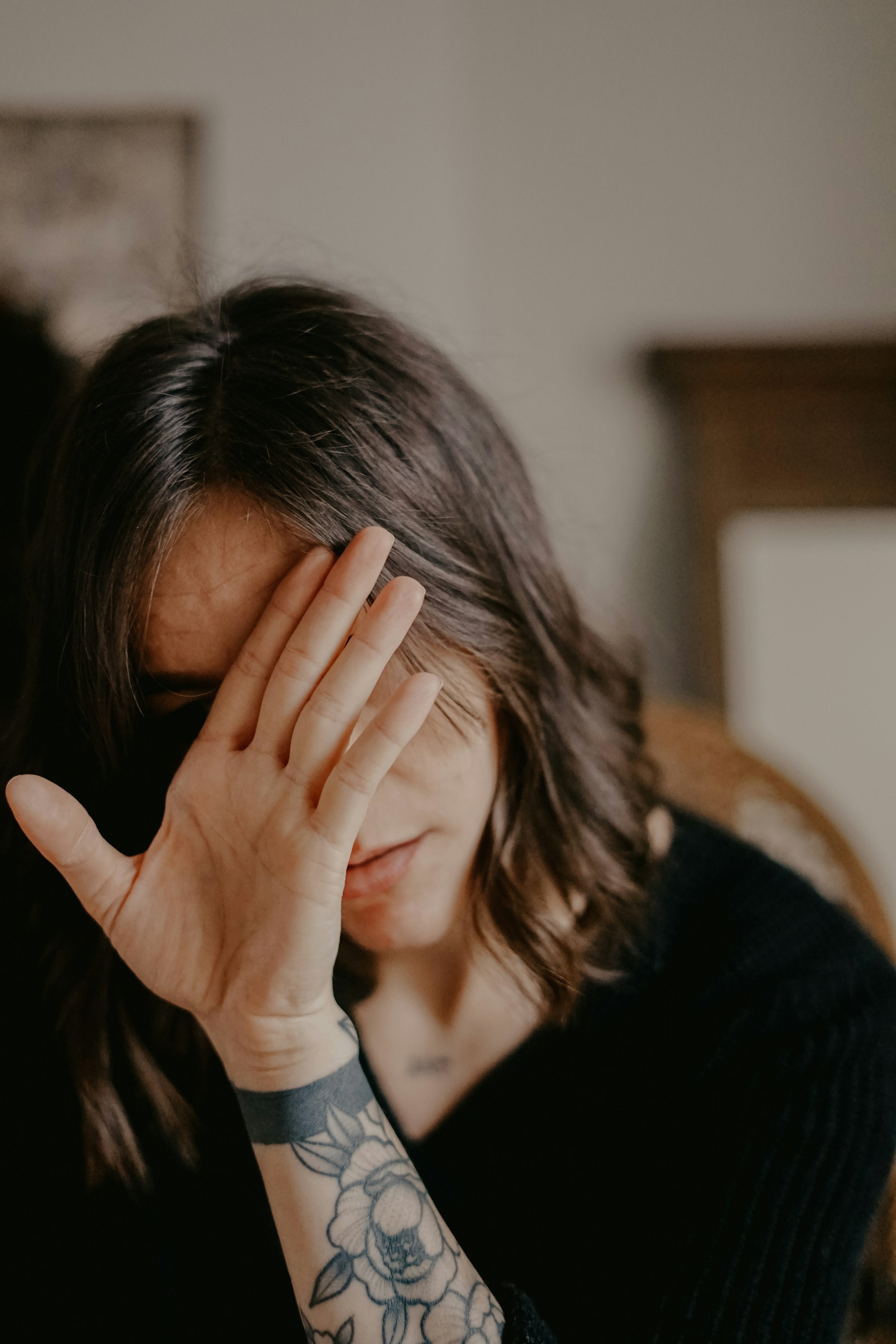 A woman covering her face | Source: Unsplash