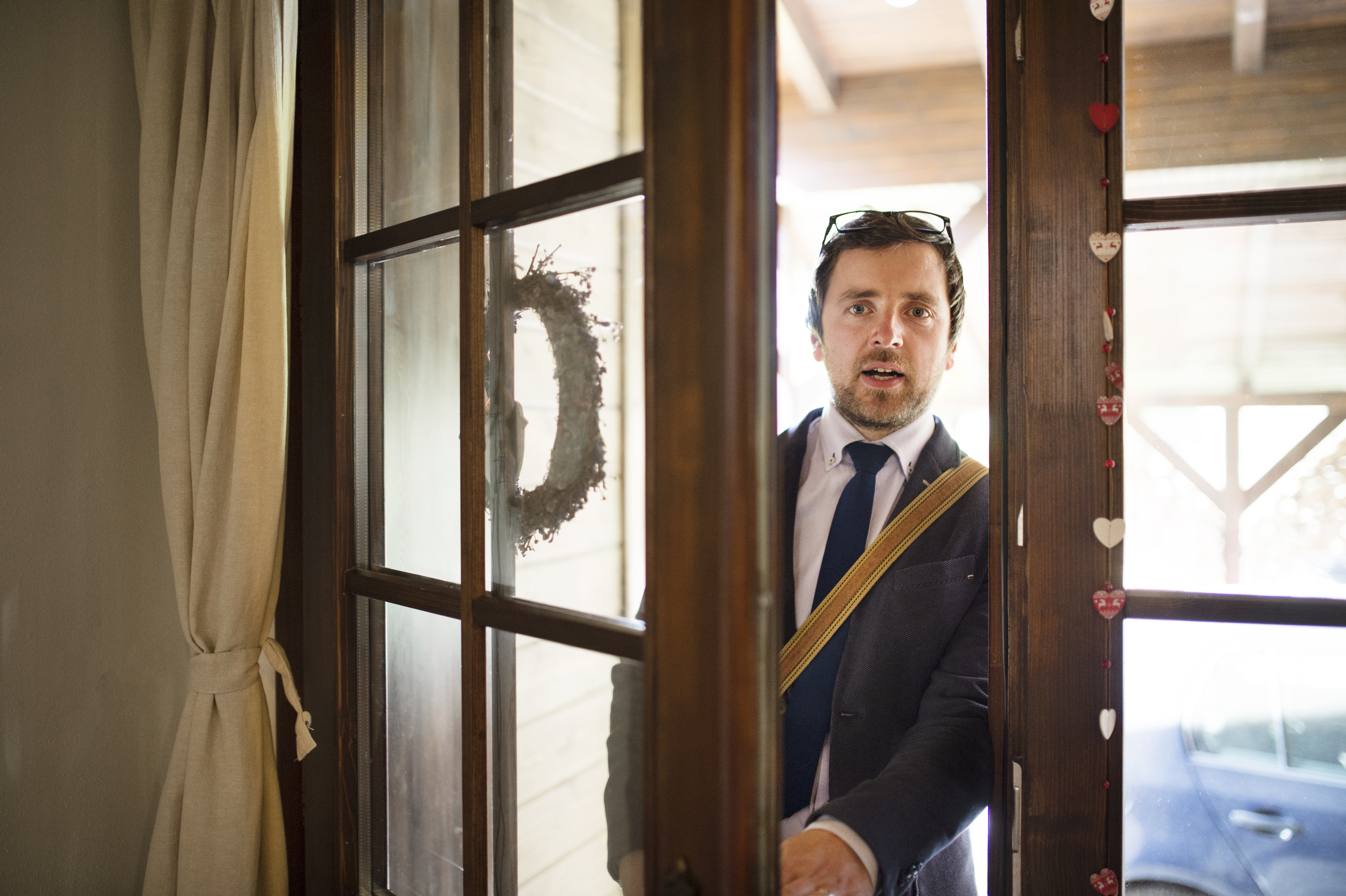 Man entering his home with a confused expression on his face | Source: Shutterstock