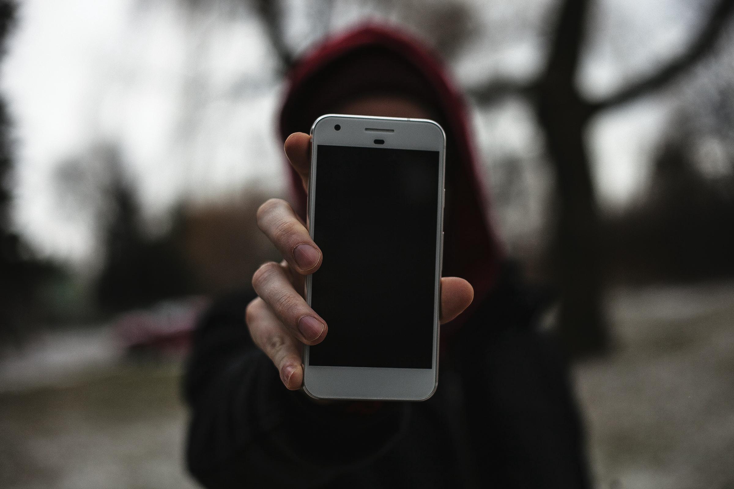 A woman holding out a phone | Source: Unsplash