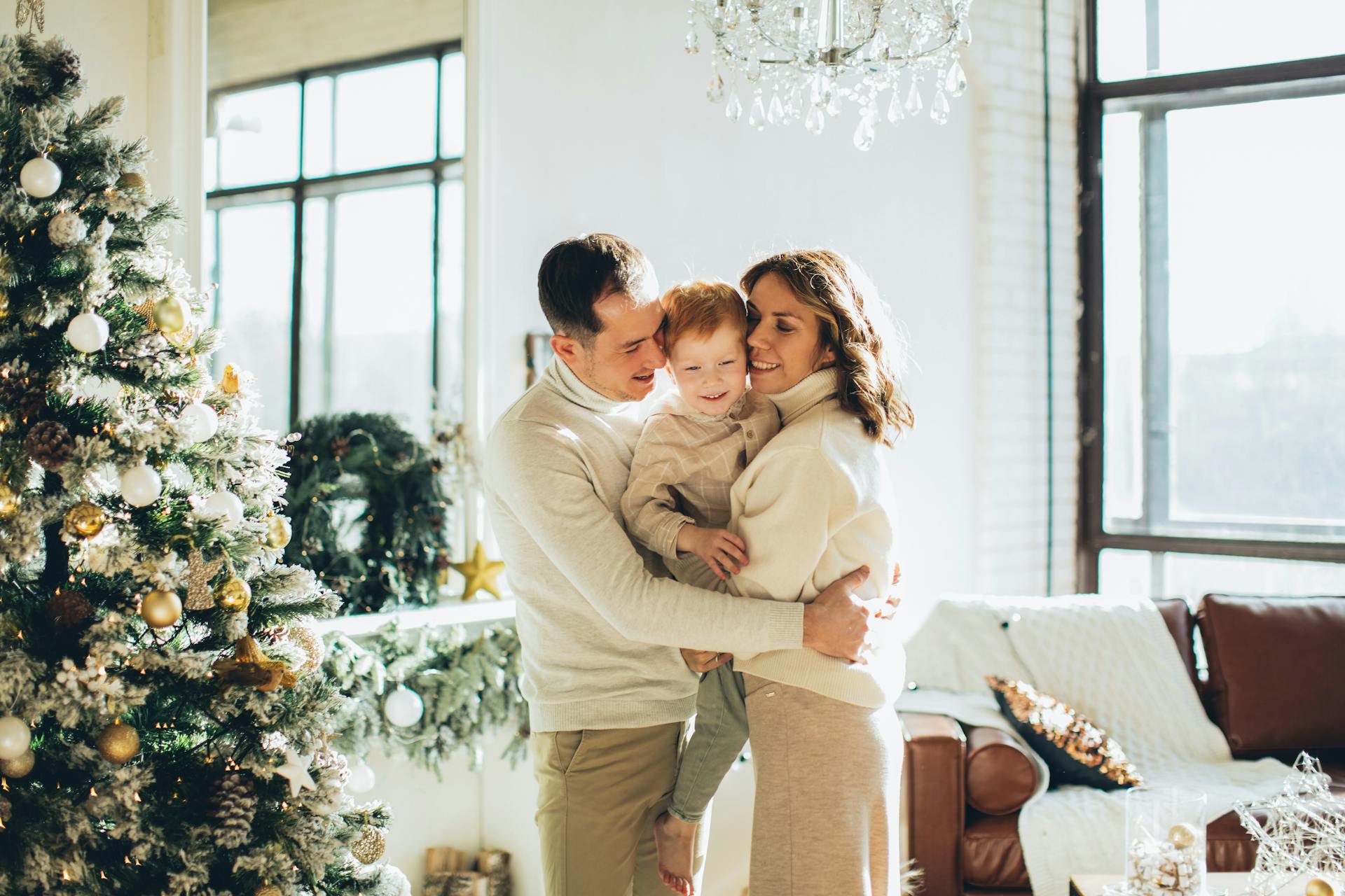 A kind couple hugging a little boy | Source: Pexels