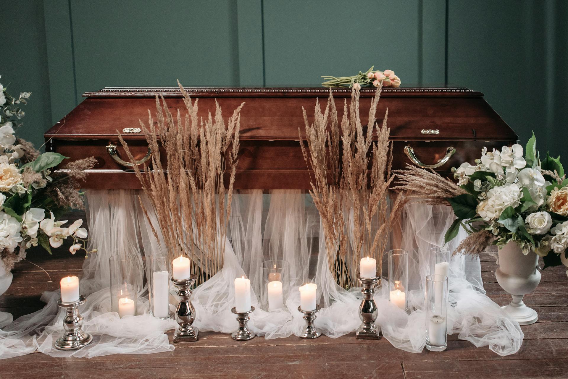 Candles near a coffin | Source: Pexels