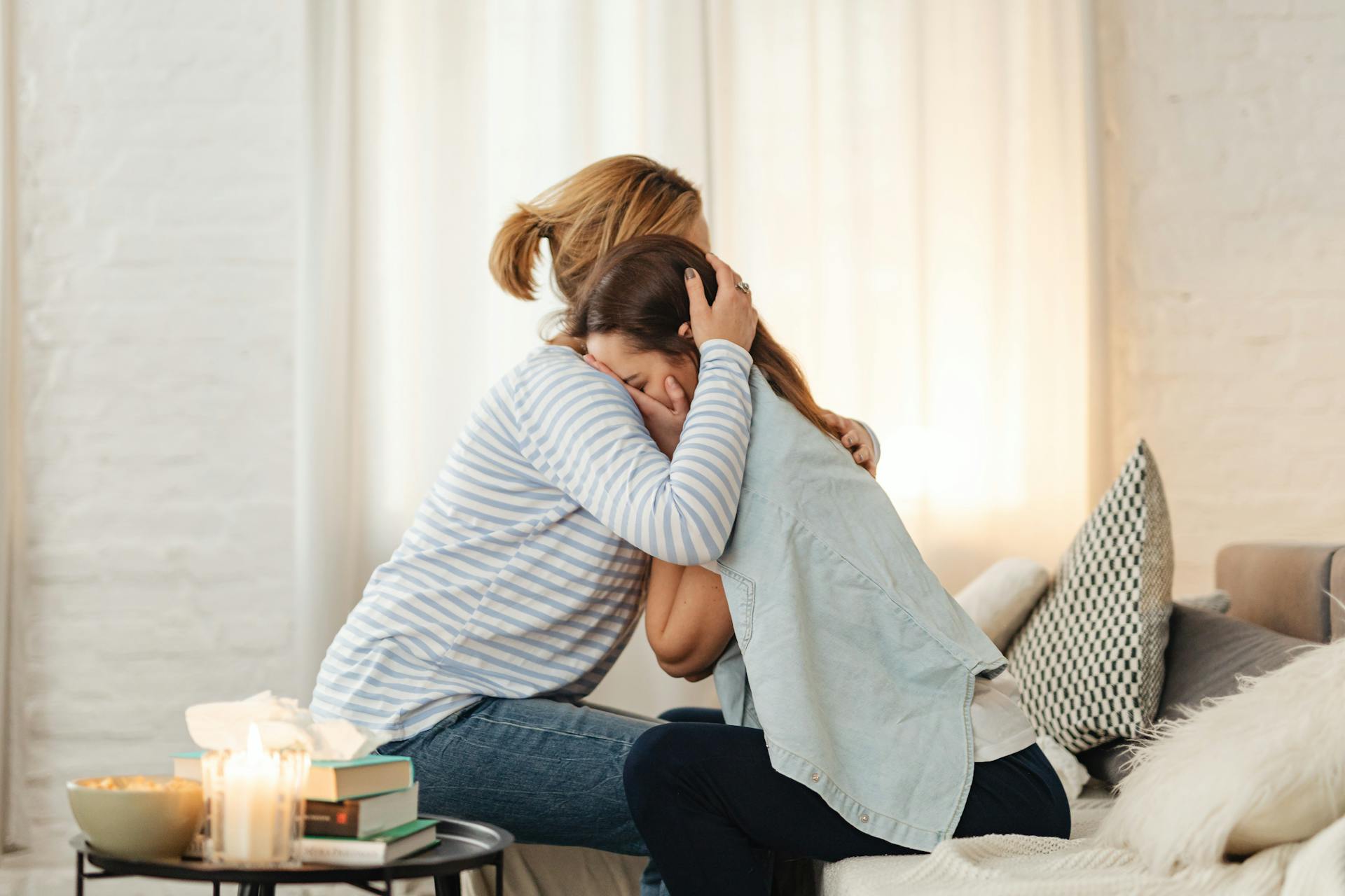 A woman hugging her daughter | Source: Pexels