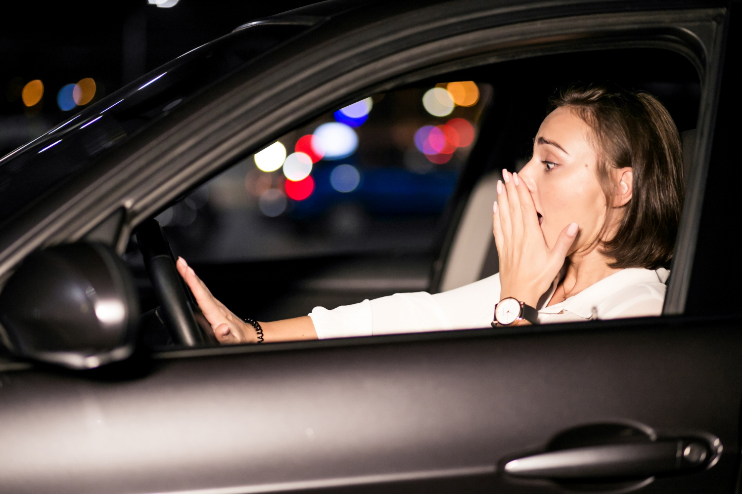 A shaken woman sitting in her car | Source: Freepik