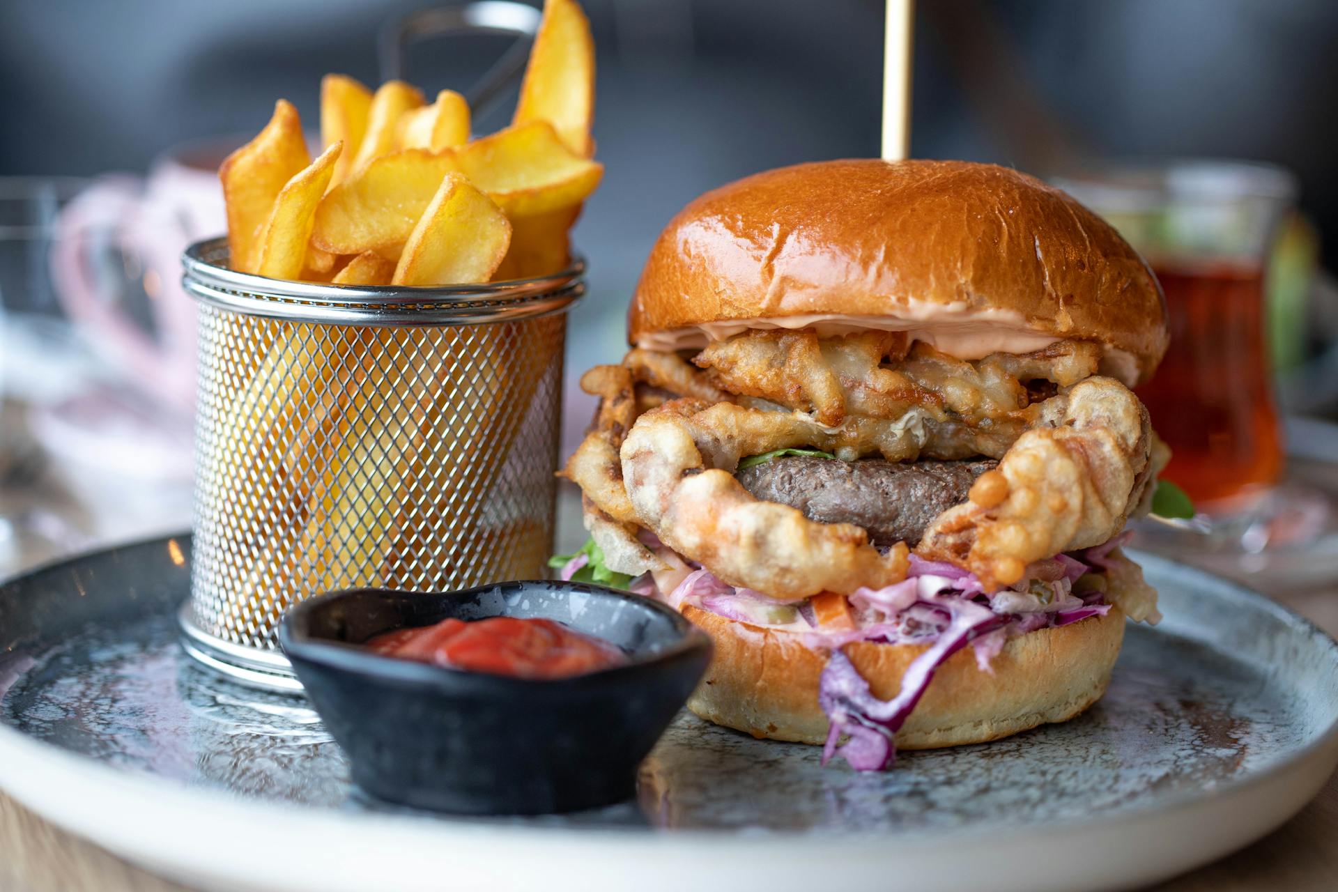A burger and fries on a plate | Source: Pexels