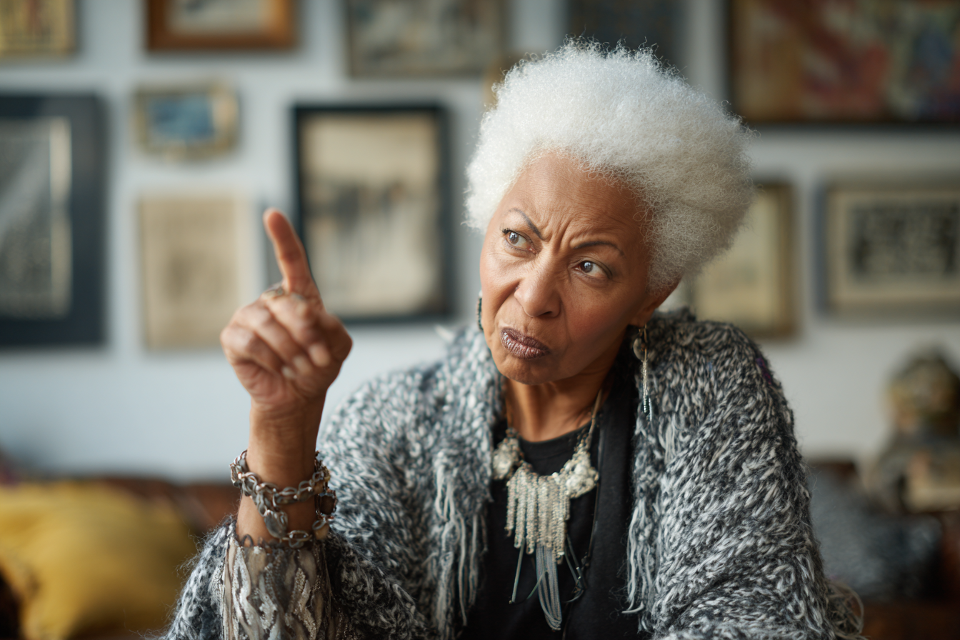 A woman pointing her finger while speaking harshly | Source: Midjourney