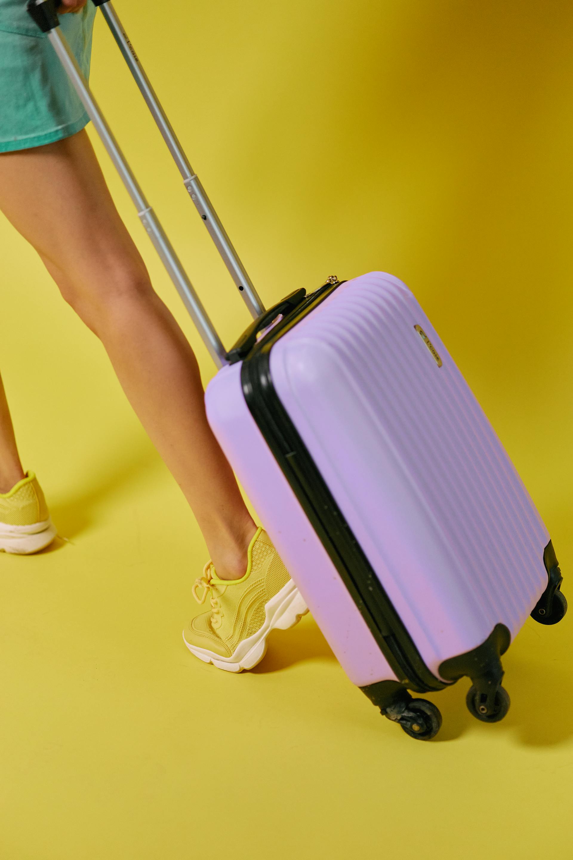 A close-up shot of a woman dragging a suitcase | Source: Pexels