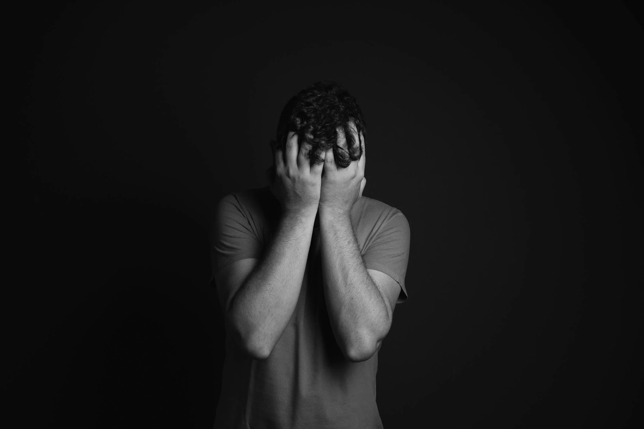 A sad man covering his face with his hands | Source: Pexels