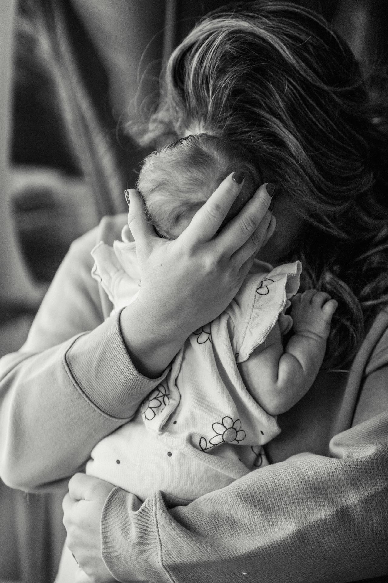 A woman hugging her baby | Source: Pexels