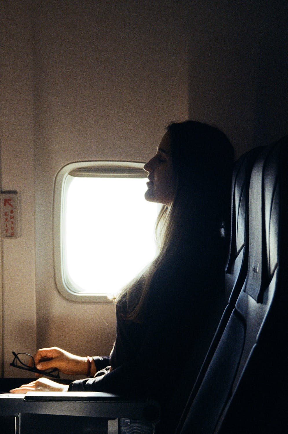 A woman settling into her window seat | Source: Pexels